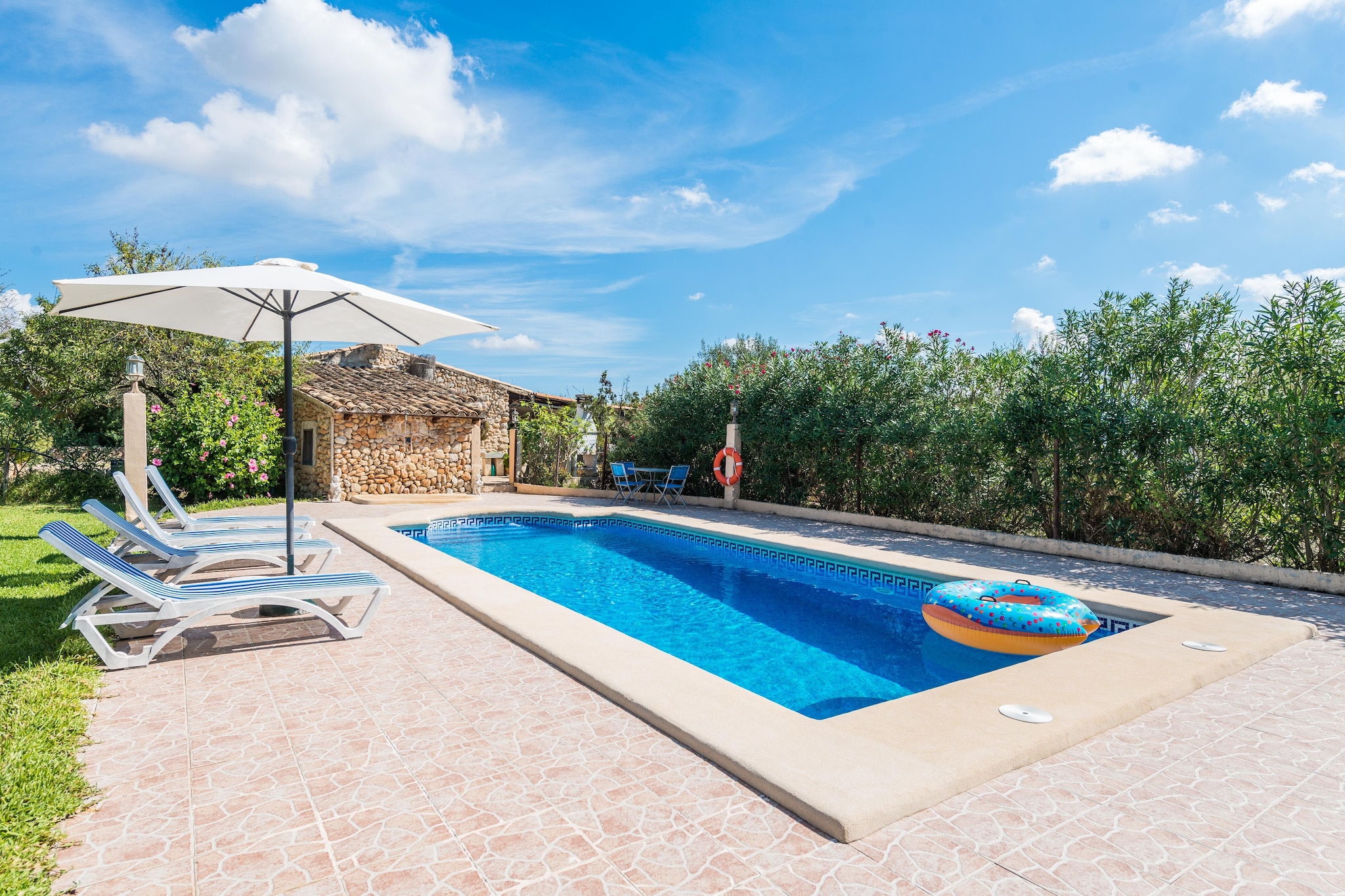 This wonderful finca accommodates a simple but really beautiful garden, where the greenery of the trees and the lawn is the perfect company to enjoy the feeling of peace you are looking for your stay. Nevertheless, the true protagonist is the superb water salt pool -surrounded by 4 sun loungers, a parasol and an outdoor shower-, where you will enjoy the fantastic weather of the island. The pool sizes 9 x 4 metres and it has a water depth ranging from 1.2 to 1.9 metres. After a perfect morning swimming in the pool, the great porch invites to prepare a delicious barbecue and, afterwards, a glass of wine while relaxing in the swinging sofa and admiring the landscape of fields full of fruit trees.
The building highlights thanks to the solar panels and the Mallorcan details like the natural stone walls, both outside and inside. When you enter, a great room featuring a fireplace welcomes you, and it combines both the living room and the dining -kitchen area, so you can be all together and don't miss a beat. You can cook on the gas stove while the others set the table, enjoy an appetiser or listen to your favourite CDs. However, the best of all is that you can cook some pop-corns and watch the satellite TV. The laundry room offers an ironing board, an iron and a washing machine. There are two rooms with a closet each, one with a double bed and space for a cot and a high chair, and the other with two twin beds. Finally, the only bathroom of the house has a shower and there are two fans available for the hottest days.
The location of the property is perfect since it is placed in the centre of the island and it has easy access to all points. You can head to any direction by car and reach it in a reasonable amount of time, like the paradisaical beaches of Puerto de Alcúdia, Playa de Muro, Can Picafort or Cala Sant Vicenç, with crystalline water and white sand. If you feel like knowing the local habits and people, Búger offers supermarkets, bars, restaurants and more, as well as other nearby towns. Specially, we recommend you visit the lovely villages of Pollensa and Alcúdia. Consult the advertiser for possible charges. Pets are not allowed. The holding of events is forbidden. There is exterior parking for 2 cars.
Distances
Beach: 18.5 km - Puerto de Alcúdia
Airport: 43.6 km - Son Sant Joan
Golf course: 24.1 km - Golf Alcanada
Town: 2.4 km - Búger
Train station: 6.9 km - Sa Pobla
Bus stop: 1.9 km - Plaça de la Constitució, Búger
Ferry: 21.8 km - Puerto de Alcúdia
Hospital: 7.5 km - Inca
Tourist license: ETV/2736Single Rental Registry: ESFCTU00000702200016311300000000000000000000ETV/27364The Ecotasa (tourist tax) must be paid cash on site when checking in. The amount varies between 0.55€/night and guest during the low season and 2.2€/night and guest during the high season. The tax is reduced by half from the 9th day of your stay. All guests have to pay the Ecotasa, except people under 16 years. You will have to pay the deposit amount at the arrival to the owner.Homerti - Central de Reservas CR/33
