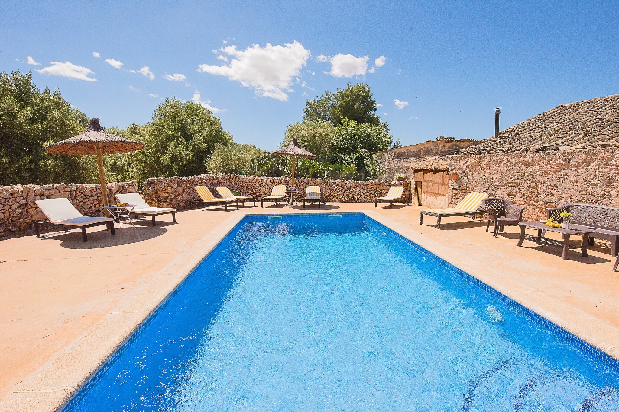 This is a wonderful Majorcan countryside house. It is very well preserved and it has all the comfort to make your holiday an unforgettable experience! The ‘possessió’ of Son Caldes is located near the town of Llucmajor and is more than 500 years old, which enhances the attractiveness of the place.
The main building has three en suite bedrooms, a spacious living room, dining room and a fully furnished kitchen with capacity for all the guests. Some old features of the house have been very well preserved. At the same time, the house is equipped with new electrical appliances, central heating and a mix of new furniture with some restored pieces. There is a wine cellar as well where you will be able to see some hand-made barrels, which were made more than 200 years ago!
In front of the main building you will find another house which is part of the whole group. This is a 2-storey house which has a very well decorated living room, a fully furnished kitchen and a bathroom on the ground floor. On the loft there is a bedroom, which is opened to the living room, with closet and two single beds. This building hasn’t got central heating, but there is a fireplace and that maintain the perfect temperature all year-round.
The 4 bedrooms have AC.
Outside the houses there is a big terrace and the pool area where you can refresh yourself during hot summer days! The terrace is furnished with tables, chairs and sun beds to enjoy dinners with family and friends or just relax sunbathing. There is a natural Mediterranean forest area and views to the countryside from everywhere!
A short drive will take you to Palma city center or to beautiful beaches as Es Trenc, Cala Pi and Sa Rápita. The town of Llucmajor is just 1.5 km away and you will be able to find facilities as local markets, supermarkets, shops, bars and restaurants.
This house is a charming place which is a little part of the history the island. At the same time, it is adapted to nowadays life and it has the comfort and personality to be the perfect place to spend your holiday! Do not hesitate to visit this vestige of the Mediterranean! Note: This accommodation is intended for families and guests over 25 years old who are looking for a peaceful stay. Bookings for parties or celebrations are not accepted. A copy of the identification document of all guests will be required to confirm the reservation. Consult the advertiser for possible charges. Pets are not allowed. The holding of events is forbidden. There is exterior parking for 4 cars.
Distances
Beach: 12 km - Cala pi
Airport: 15 km - Palma
Golf course: 17 km - Son Antem
Town: 1.5 km - Llucmajor
Train station: 20 km - Palma
Bus stop: 1.5 km - Llucmajor
Ferry: 20 km - Palma
Hospital: 18.5 km - Son Llatzer
Tourist license: ETV/3535Single Rental Registry: ESFCTU0000070180000403250000000000000000000000ET35359The Ecotasa (tourist tax) must be paid cash on site when checking in. The amount varies between 0.55€/night and guest during the low season and 2.2€/night and guest during the high season. The tax is reduced by half from the 9th day of your stay. All guests have to pay the Ecotasa, except people under 16 years. You will have to pay the deposit amount at the arrival to the owner.Homerti - Central de Reservas CR/33