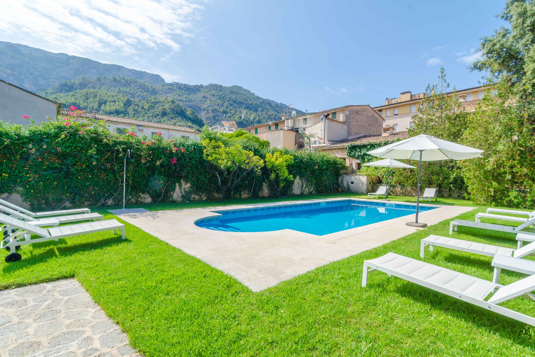 Welcome to this majestic two building house, with idylic outers, including a chlorine 9m x 4m, and a deph ranging that goes from 1.20m to 1.80m, surrounded by grass, and different terraces where relax, having a drink and reading a good book will be a pleasure. You can prepare delicious barbecues with your loved ones.

The big building divides its rooms in three floors including: a beautiful living-room with a satellite TV, a big dining-room with space for 18 guests, an equipped gas industrial kitchen with all the amenities you might need during your stay, and seven bedrooms with a bathroom en suite each, all of them with a bath. All the bedrooms dispose of a double bed, except one with two single beds, and a wardrobe, air conditioning and central heating. Three of them are located at the first floor, three at the second floor and the last one at the third. Obviously, there is a laundry area equipped with a washing machine, a dryer, an iron and an ironing board. For the little ones of the family, we can offer up to two cots and two high chairs.

The property is located right at the center of Sóller, a gorgeous village from  Sierra de Tramuntana, with all the services you might need. A must visit is Sant Bartomeu church, wich date back to 1236. 
You can also find a lot of restaurants, bars and supermarkets. By train or bus you can go to Puerto de Sóller and its idylic sandy beaches. Around the area there are a lot of gorgeous routes to do and beautiful villages. We recommend to visit the capital, Palma. La Tramuntana counts with unforgettable coves, like Cala Deià, Llucalcari or Port des Canonge.

From Monday to Friday, you dispose of cleaning service.
Remember that the tanker is not potable.
The annex building is not available. Note: This accommodation is intended for families and guests over 20 years old who are looking for a peaceful stay. Bookings for parties or celebrations are not accepted. A copy of the identification document of all guests will be required to confirm the reservation.  Consult the advertiser for possible charges. Pets are not allowed. The holding of events is forbidden. There is exterior parking for 3 cars.  
Distances
Beach: 13.3 km - Cala Deia
Airport: 34.7 km - Son Sant Joan
Golf course: 18 km - Son Termens
Town: 0.4 km - Soller
Train station: 0.4 km - Soller
Bus stop: 0.4 km - Ctra. de Desviament, Soller
Ferry: 40 km - Port de Palma
Hospital: 34 km - Son Espases
Tourist license: TI/48Single Rental Registry: ESFCTU00000702800010761400000000000000000000000TI/488The Ecotasa (tourist tax) must be paid cash on site when checking in. The amount varies between 0.55€/night and guest during the low season and 2.2€/night and guest during  the high season. The tax is reduced by half from the 9th day of your stay. All guests have to pay the Ecotasa, except people under 16 years. Homerti - Central de Reservas CR/33 Electricity (January - December): 0.26 EUR/KW (mandatory) <br> <br />