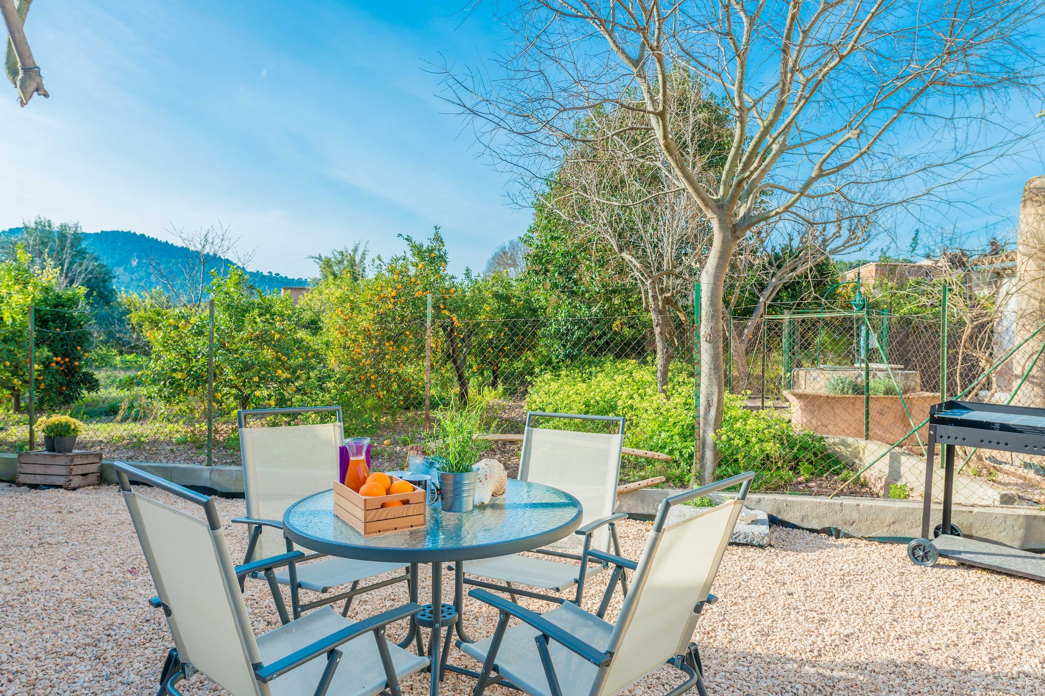 The house has a large outdoor patio where you can enjoy a fantastic breakfast or a delicious dinner prepared on the barbecue. All this with a glass of wine and the emblematic views of nature.
The house, of about 200 m2, is distributed over three floors, including a living-dining room, a fantastic kitchen and a total of four bedrooms with wardrobe and views of the village, and two bathrooms. Both the living room and the bedrooms have air conditioning.
On the ground floor, the warm and spacious kitchen, with direct access to the outside, has all the necessary utensils to cook your favourite dishes, including ceramic hob, industrial appliances and large cupboards. The living-dining room invites you to relax on the comfortable sofa while watching a film on the satellite TV or listening to some music. There is a bathroom with shower and a separate room with washing machine, iron and ironing board. After a couple of steps, there is a bedroom with a double bed.
On the next floor, there are two more bedrooms, one with a double bed and en-suite bathroom with shower and bathtub, and the other with two single beds. On the top floor, there is a fourth bedroom with a double bed. A cot and a highchair for a baby are available.
You will only have to walk 500 metres to get to the centre of the village, where you can visit its most emblematic building which is the church of Sant Bartomeu, whose beginnings date back to 1236. There is a wide variety of supermarkets, cafés and restaurants, where we recommend you to try a delicacy, the prawns, which are the star dish of the area. By tram or bus you can go to Puerto de Sóller and its wonderful sandy beach. Around it there are many beautiful routes and excursions, the most famous being a trip on the old train to Palma, passing through beautiful landscapes and genuine villages until you reach the capital of Mallorca. The Tramuntana has incredible coves, especially rocky ones such as Cala Deià, Llucalcari or Port des Canonge, and small charming villages such as Fornalutx, Biniaraix or Deià.
The fenced area with orange trees is not available for our guests. Consult the advertiser for possible charges. Pets are not allowed. The holding of events is forbidden.
Distances
Beach: 9 km - Port de Soller
Airport: 32 km - Son Sant Joan
Golf course: 30 km - Golf Son Termes
Town: 0.5 km - Soller
Train station: 2 km - Sóller
Bus stop: 1 km - Ctra. Palma-Soller
Ferry: 38 km - Port de Palma
Hospital: 23 km - Son Espases
Guests are kindly required to dispose of all rubbish and ensure the property is properly tidied before departure. Should this not be the case, a charge of €90 will be deducted from the security deposit. Tourist license: ETV/8678Single Rental Registry: ESFCTU00000702800036554000000000000000000000ETV/86785There's a mandatory tourist tax in Balearic Islands, called Ecotasa. All guests, except people under 16 years, have to pay this tax. The amount varies between 0.55€/night and guest during the low season and 2.2€/night and guest during the high season .The tax is reduced by half from the 9th day for your stay. Homerti - Central de Reservas CR/33