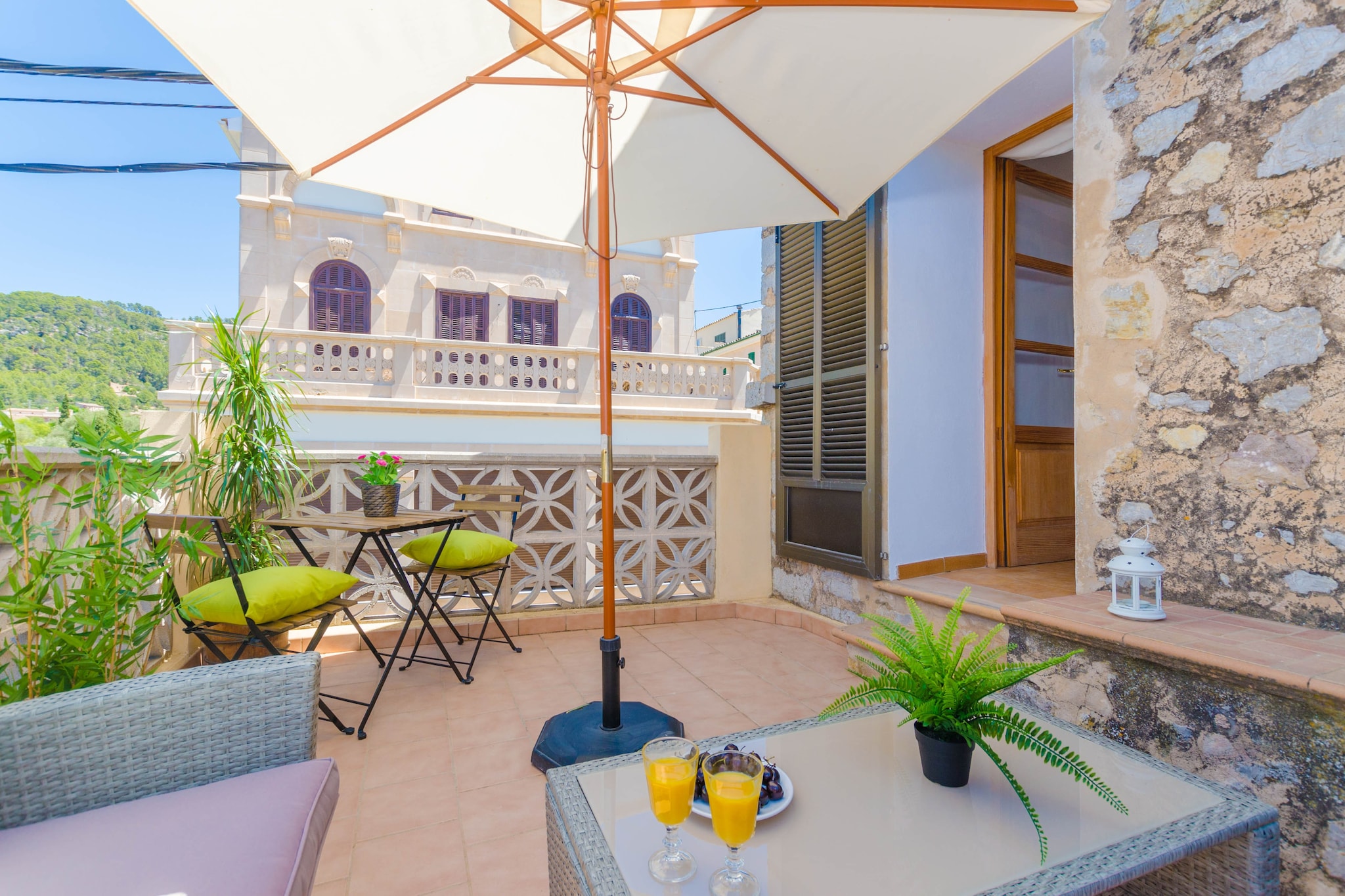 You will feel the rustic charm of the antic Mallorca from the spectacular terrace of this impressive town house. It offers a wonderful chill-out with a comfortable sofa and two armchairs together with a little table where you can enjoy an appetiser and admire the beautiful mountain views. At night, this is the perfect place to cool down after a long day at the beach or making an excursion, enjoying a glass of champagne under the wonderful starry sky. This is a town house with neighbours around.
The spacious three storey house offers a special traditional style with wooden beams and stone walls here and there, spotted by some more modern corners. The cosy living room, on the ground floor, offers two armchairs and a sofa where you can watch TV while you refresh with the AC (or while you warm up by the wood stove on the coldest days), and a dining table. Then you have the kitchen with the basic equipment to cook during your vacation, with a gas top. The house also offers a washing machine, an iron and an ironing board. The house has 5 bedrooms, with AC and a wardrobe each of them, and three bathrooms. There is a twin bed bedroom on the ground floor. Two more bedrooms are on the first floor: one with two twin beds, and the other with a double bed and the only access to the chill-out terrace. The second floor offers the last two bedrooms, both with a double bed. There is one bathroom on each floor, two with a bath and a bidet each and the last one with a shower. The stairs connecting the three floors of the house have no railing. If you are travelling with your baby we can prepare a cot and a high chair.
S'Arracó is a little village in the southwest of Mallorca, belonging to the municipality of Andratx. It is located in a little valley at the foot of the Tramuntana mountain range. So this is an excellent starting point for hiking and biking excursions. The sea also is near, about 4.1 km away in Sant Elm, so it also is a perfect place for a beach vacation. The village offers the basic services for an independent stay. You will have to visit the beautiful town of Andratx for anything else. You cannot miss either the luxurious port of Andratx and be delighted by the wonderful views. Consult the advertiser for possible charges. Pets are not allowed. The holding of events is forbidden.
Distances
Beach: 4.1 km - Sant Elm
Airport: 46 km - Son Sant Joan
Golf course: 19.9 km - Golf Fantasia
Town: 0.01 km - S'Arracó
Train station: 32.9 km - Palma
Bus stop: 5 km - Andratx
Ferry: 29.2 km - Puerto de Palma
Hospital: 33.6 km - Son Espases
Tourist license: ETV/10561Single Rental Registry: ESFCTU0000070320000248260000000000000000000ETV/105619Homerti - Central de Reservas CR/33 Air Conditioning (January - December): 25 EUR/Night (optional) <br> <br />
