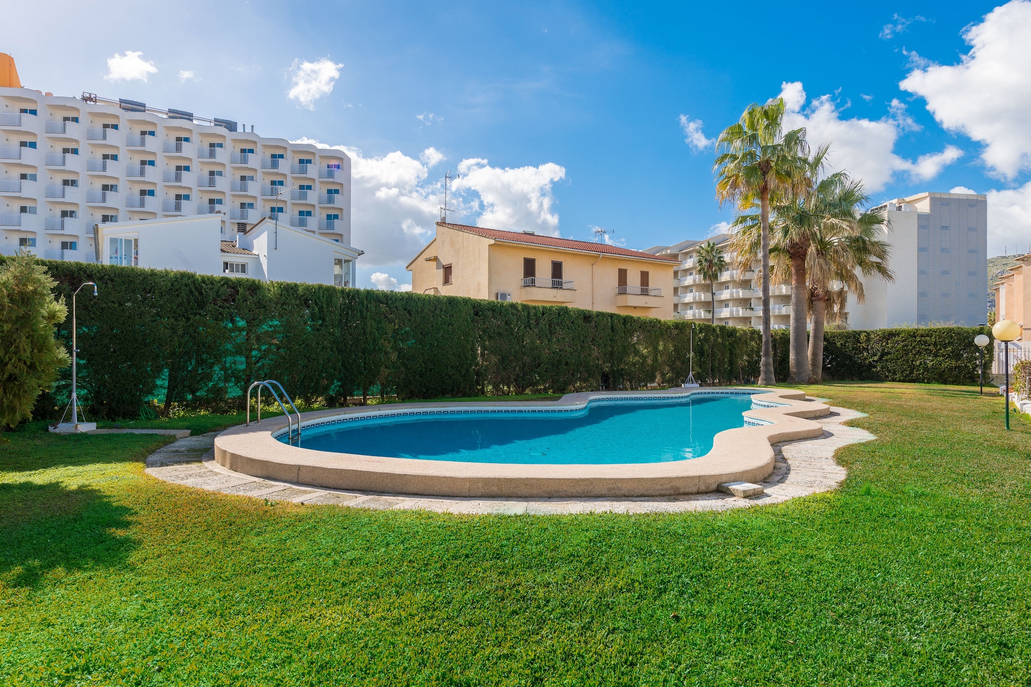 A beautiful furnished balcony with views to the shared pool and garden is perfect to start the day with a succulent breakfast before going downstairs to bask in the sun on one of the two sun loungers that you will find at the private terrace of the ground floor or maybe enjoy a cool dip in the salt water pool. It sizes 10 x 5 metres and the water depth ranges from 0.3 to 1.5 metres. There is a exterior shower where you can wash the sand and salt off after a long day at the beach which is only 1 km away from the apartment. And in order to end your day, nothing like a delicious barbecue!

The apartment comprises three floors. On the ground floor (on the pool level) you will find the garage, laundry room -with washing machine, iron and ironing board- and a shower bathroom. On the first floor we have the comunal rooms: the spacious living - dining area (with TV-Sat) open to the kitchen. This is joyful and funny inviting to cook delicious recipes on the ceramic top or the oven. Finally, the second floor offers a bathtub bathroom and the two bedrooms, both with a closet. One has a double bed and the other has twin beds. We can prepare a cot and a high chair if you are travelling with your baby. Finally, there is air conditioning both in the living - dining room and in the bedrooms.

The location of this apartment is perfect since all needed services are in a walking distance: bars, restaurants, ice-cream parlours, supermarkets, etc. The beach of Puerto de Alcudia is the nearest one just a short walk away but we highly recommend visit other beaches like the one of La Victoria. Every Tuesday and Sunday you can go the street market in the town of Alcudia where you can acquire local and artisan products.

The all year round pool is open from 9 am to 10 pm. Consult the advertiser for possible charges. Pets are not allowed. The holding of events is forbidden. There are parking space for 1 cars in the garage. Please note that the opening and closing dates of the communal pool are subject to community regulations and may vary depending on the season, without prior notice. Updated information will be available upon your arrival.
Distances
Beach: 1 km - Puerto de Alcúdia
Airport: 61.2 km - Son Sant Joan
Golf course: 4.8 km - Club de Golf d'Alcanada
Town: 0.01 km - Puerto de Alcúdia
Train station: 14.5 km - Sa Pobla
Bus stop: 5.8 km - Puerto de Alcúdia
Ferry: 2.5 km - Puerto de Alcúdia
Hospital: 25.9 km - Hospital Comarcal d'Inca
Tourist license: ETVPL/14339Single Rental Registry: ESFCTU00000704300018811100000000000000000ETVPL/143398