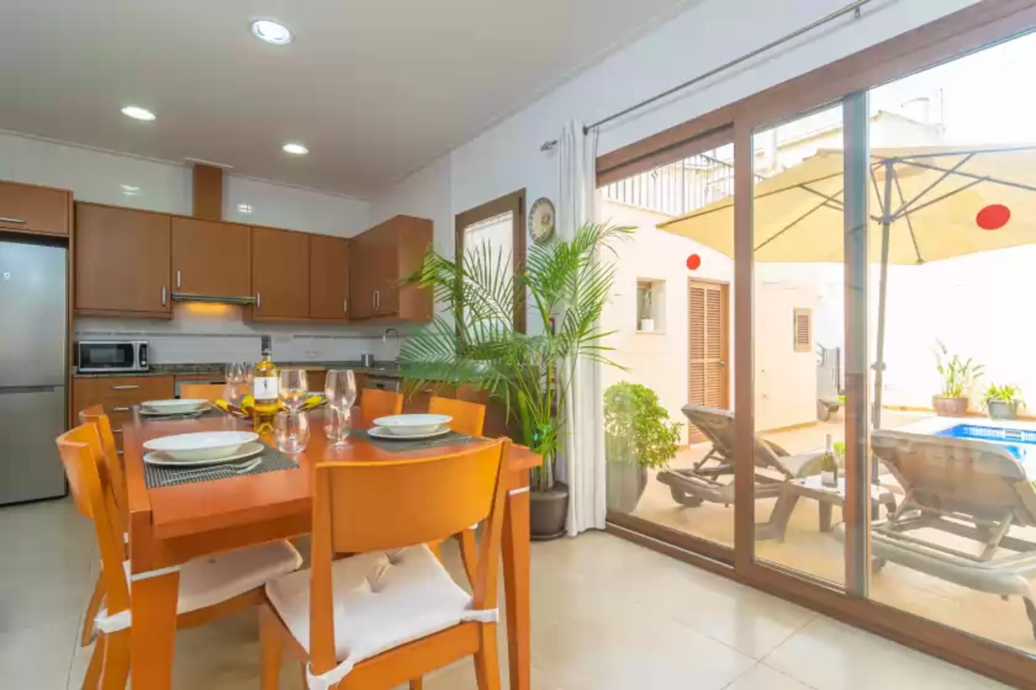 On the terrace of this cosy two-storey house you are sure to have a great time with your companions. You will be able to enjoy a good breakfast in the open air or a delicious barbecue, whenever you wish, while you take a dip in the salt pool. It measures 5.50m x 3.60m and has a depth of between 1.55m and 1.70m. When you get out, you can sunbathe on one of the sun loungers or have a drink on the sun terrace, which you can access via the exterior stairs.
Distributed over two floors, the interior of the house is designed to offer you the rest you deserve. On the main floor there is a living room equipped with Smart TV and satellite TV so you can enjoy your favourite programmes and feel at home. The dining room is next to the kitchen and has direct access to the terrace and the swimming pool. You will be able to prepare delicious dishes in the vitro-ceramic kitchen, which is equipped with all the utensils you need to cook comfortably. There is also a washing machine, iron and ironing board. On the same floor you will find a bedroom with two single beds and two bathrooms with shower. A staircase leads to the upper floor, where you will find the other bedrooms and the terrace, which can also be accessed from the outside. Of the four bedrooms on this floor, one has two single beds and the other three have double beds. One of the bedrooms with a double bed also has an en suite bathroom with bathtub and direct access to the terrace. A bathroom with shower completes this floor. All rooms have AC and if you are travelling with your baby we can provide you with a cot and high chair.
The property is located in Sa Pobla, which is perfect for strolling around the village as it is close to bars, restaurants and shops. In addition, on Sundays there is a traditional market with fresh local fruit and vegetables and many other artisan products. The property has a parking space, but if you wish, just 700 metres away there is a bus or train stop to go to nearby villages or to the capital of the island. If you want to enjoy the beach, you can reach the beaches in the north of the island in only 10 minutes by car. If you like golf, the Golf Pollença is only 15 minutes away by car. Note: This accommodation is intended for families and guests over 23 years old who are looking for a peaceful stay. Bookings for parties or celebrations are not accepted. A copy of the identification document of all guests will be required to confirm the reservation. Consult the advertiser for possible charges. Pets are not allowed. The holding of events is forbidden. There are parking space for 1 cars in the garage.
Distances
Beach: 10.9 km - Platja de Muro
Airport: 50.8 km - Palma de Mallorca
Golf course: 11.6 km - Golf Pollença
Town: 0.45 km - Sa Pobla
Train station: 0.75 km - Sa Pobla
Bus stop: 0.7 km - Sa Pobla
Ferry: 17.3 km - Alcudia
Hospital: 9.5 km - Hospital Juaneda Muro
Tourist license: ETV/9434Single Rental Registry: ESFCTU00000703000038882500000000000000000000ETV/94340There's a mandatory tourist tax in Balearic Islands, called Ecotasa. All guests, except people under 16 years, have to pay this tax. The amount varies between 0.55€/night and guest during the low season and 2.2€/night and guest during the high season .The tax is reduced by half from the 9th day for your stay.