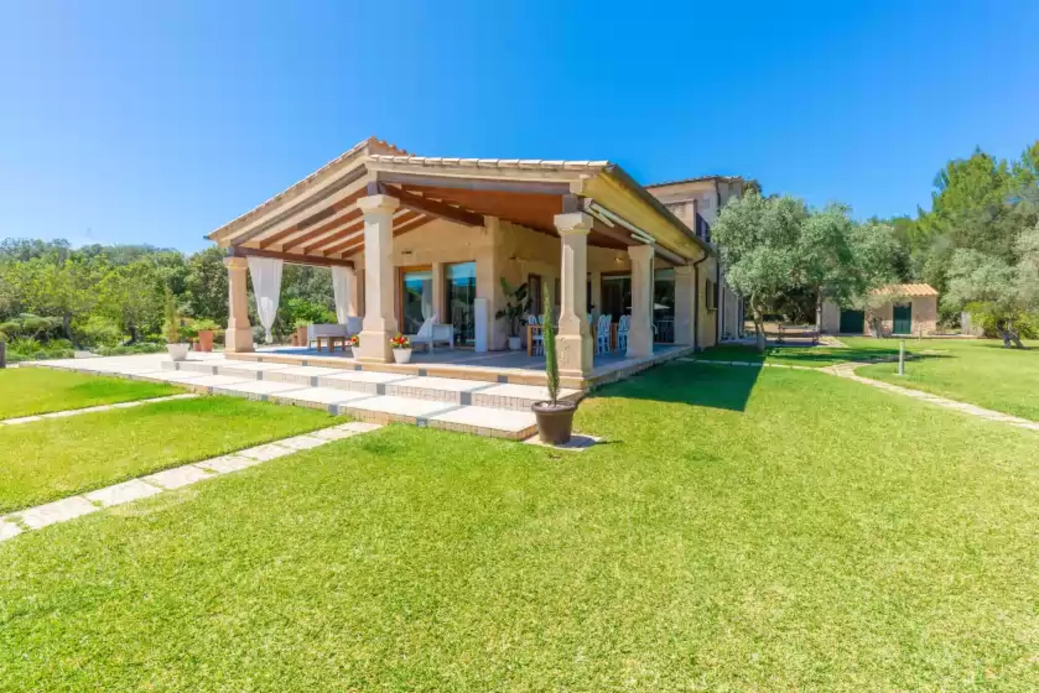 This magnificent villa offers a very extensive exterior with a very well maintained garden with mountain views, ideal to enjoy the evenings with your companions. In the garden is the private chlorine pool which measures 12m long x 5m wide and its depth ranges from 1.50m to 2.00m. Next to the pool is the jacuzzi, perfect for relaxing in the Mediterranean sun. For sunbathing, the garden has 4 sunbeds and 2 sun loungers. Near the pool you will find a fully furnished porch with tables and chairs and a barbecue, perfect for preparing a delicious meal after a swim in the pool. Before entering the house, you will find a second porch, also furnished for outdoor dining. There is a ping-pong table to spend the afternoons playing outdoors.
The interior of the house, distributed over 3 floors, is designed for maximum comfort. The living room has two sofas next to the Smart TV, and A/C to make evenings watching movies more refreshing. It also has a dining area where you can enjoy, with all the guests, the meals prepared in the induction cooker fully equipped with all the necessary utensils to cook during your stay. When it comes to sleeping you will find 3 bedrooms on the ground floor, one of them with a double bed with wardrobe and an en-suite bathroom with bathtub. The two bedrooms on this floor have two single beds and wardrobe, and one of them has an en-suite bathroom with bathtub. To complete this floor, there is another bathroom with shower. Going up the stairs, you will find the last bedroom. This room stands out for having a dressing room and an exit to a small terrace with two hammocks ideal for sunbathing. It also has a double bed and an en-suite bathroom with shower and bathtub. Three of the bedrooms have A/C. For more comfort, you can make use of the washing machine, dryer, iron and ironing board available in the house. If you are travelling with a baby, a cot and high chair will be provided.
This superb accommodation is located very close to Pollença, a charming town at the foot of the Serra de Tramuntana mountain range known for its rich history, stunning natural beauty and vibrant atmosphere. One of the main attractions of Pollença is its historic centre. With its narrow cobbled streets, picturesque squares and beautiful buildings, it is a perfect place to stroll and explore. Here you will also find a wide variety of bars and restaurants where you can sample the local gastronomy. If you fancy a day in the sun and sea, the beach of Puerto de Pollença, with its fine sand and crystal clear waters, is an idyllic place to enjoy a wide range of water sports or simply relax on a sun lounger and enjoy the sun and the sea breeze.
The house has a wine cellar with a variety of wines which can be purchased at an additional cost. You will have more information from the owner on the day of arrival. Consult the advertiser for possible charges. Pets are not allowed. The holding of events is forbidden. There is exterior parking for 3 cars.
Distances
Beach: 8.2 km - Platja d'Alcúdia
Airport: 62.7 km - Palma de Mallorca
Golf course: 2 km - Pollença Golf Club
Town: 5 km - Pollença
Train station: 13 km - Sa Pobla
Bus stop: 4.4 km - Pollença
Ferry: 10.7 km - Platja d'Alcúdia
Hospital: 4.4 km - Centre de Salut de Pollença
Tourist license: VT/1668Single Rental Registry: ESFCTU000007030000547055000000000000000000000VT/16680There's a mandatory tourist tax in Balearic Islands, called Ecotasa. All guests, except people under 16 years, have to pay this tax. The amount varies between 0.55€/night and guest during the low season and 2.2€/night and guest during the high season .The tax is reduced by half from the 9th day for your stay.