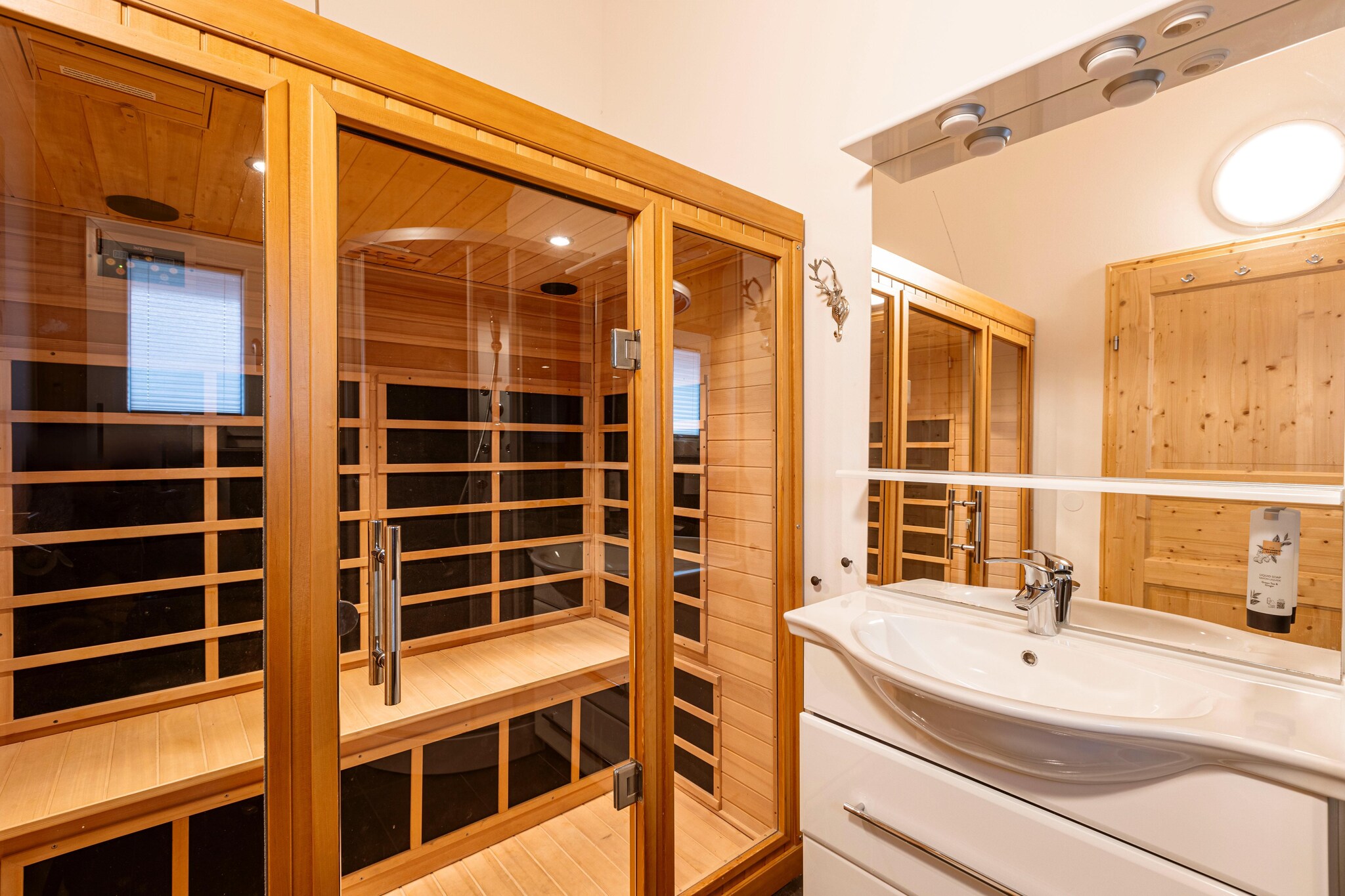 Living room(TV(satellite), seating area), open kitchen(electric kettle, toaster, cooker(ceramic), coffee machine(filter, fully automatic), oven, microwave, dishwasher, fridge-freezer), bedroom(double bed), bedroom(double bed), bathroom(shower, infrared sauna, washbasin, toilet, hairdryer), mezzanine(double bed), Internet access, balcony, parking