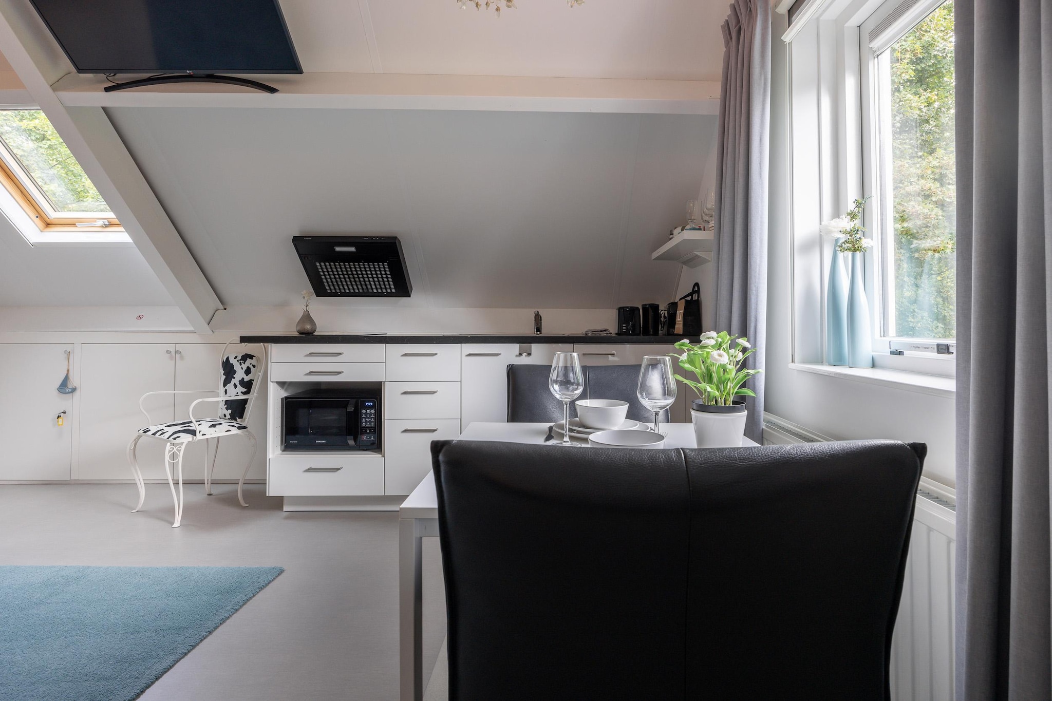 On the 1st floor: (open kitchen(electric kettle, toaster, cooker, coffee machine, oven, fridge), Living/bed room(double bed, TV, dining table), bathroom(shower, washbasin, toilet))\n\nterrace, parking