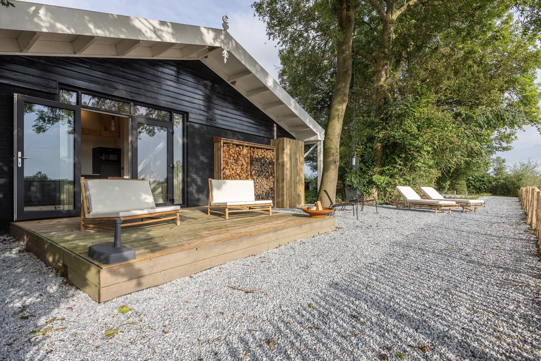 Ground floor: (Living room(dining table, seating area), open kitchen(cooker, coffee machine, oven), bedroom(double bed), bathroom(shower, washbasin, toilet))\n\nterrace, garden, parking