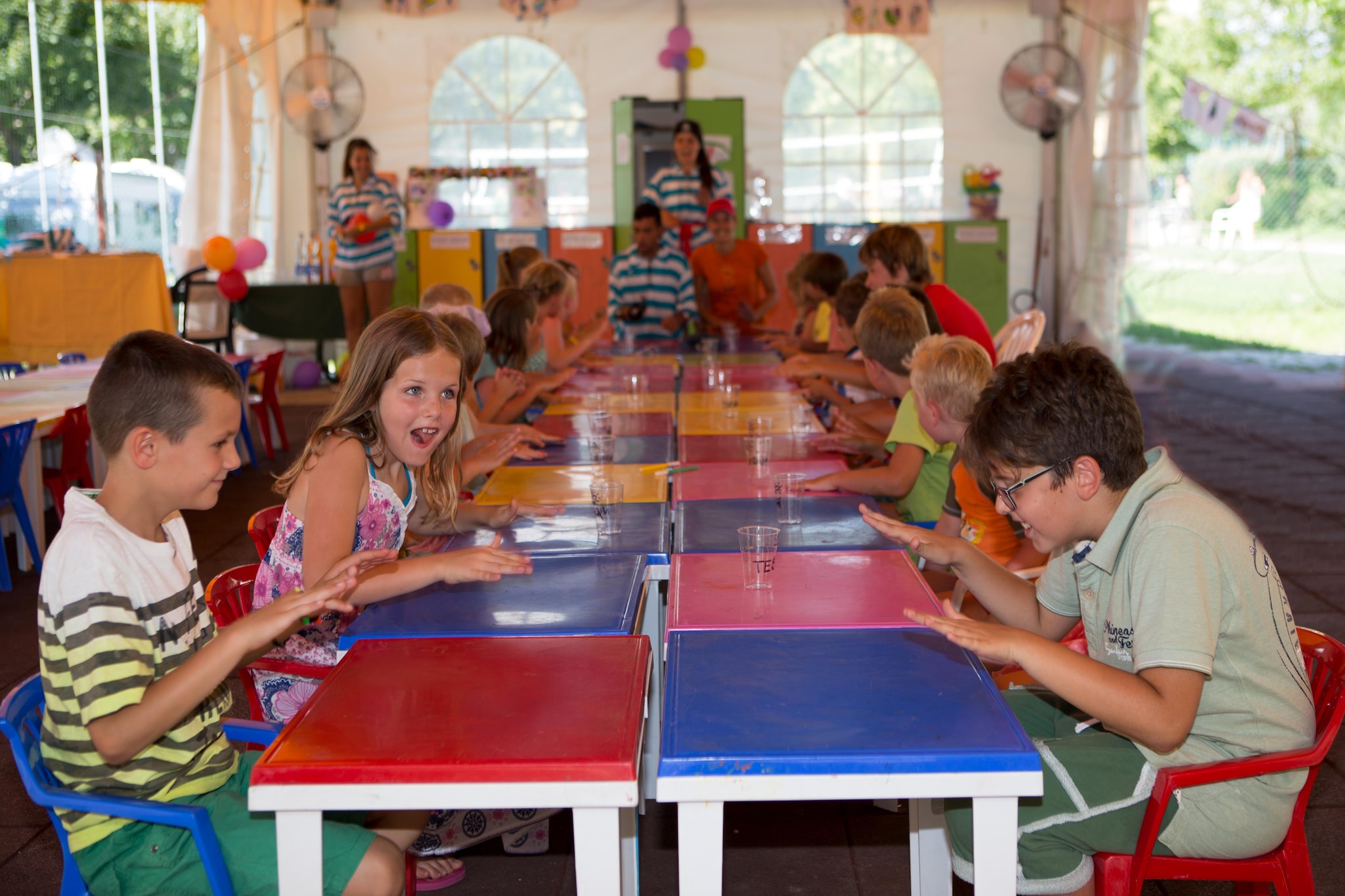 Large park of 240,000 square meters between Lazise and Pacengo, built on natural terraces that extend to the lake shore. Despite the vastness of the area, you can still quickly get to the lake with its own beach for swimming and relaxing. Depending on the location, it is a maximum of 900 meters. A lively complex for the whole family. Whether in the spacious pool area of around 1,700 square meters with water slides, during sports activities or during the children's entertainment - there is something for everyone here! The following applies to the complex:
- 450 residential units
- Reception
- Restaurant
- Mini market
- Bar
- Water landscape
- Mini club
- Restaurant, pizzeria
- Various sports facilities (tennis, mini golf, table tennis, beach volleyball, gym, padel court - some for a fee)
- WiFi
- Washing machine (for a fee)
- Tumble dryer (for a fee)
- Garden
- Parking (one parking space per accommodation free of charge), additional parking spaces only on request and for a fee on site (approx. EUR 13).

Activities nearby: The largest amusement parks in Italy are located on Lake Garda, including Gardaland, which is one of the number one parks in Italy. Travel through different eras such as the Wild West or ancient Egypt to get to your next attraction. If you are more interested in the cool water, then visit the Canevaworld water park with white beaches, glittering lagoons, waterfalls and slides. It can be reached on foot in just 10 minutes. Alternatively, those who want to relax can choose from numerous thermal baths in the surrounding area. One of these is located in the hinterland of Lazise, in ColÃ€;

Mobility: Not suitable for people with reduced mobility

- Charging stations for electric cars inside the campsite are free.

- Chairs and deckchairs by the pools subject to availability, without guarantee of
availability for all guests of the village

- Motorcycles are not allowed (please use the outdoor parking).