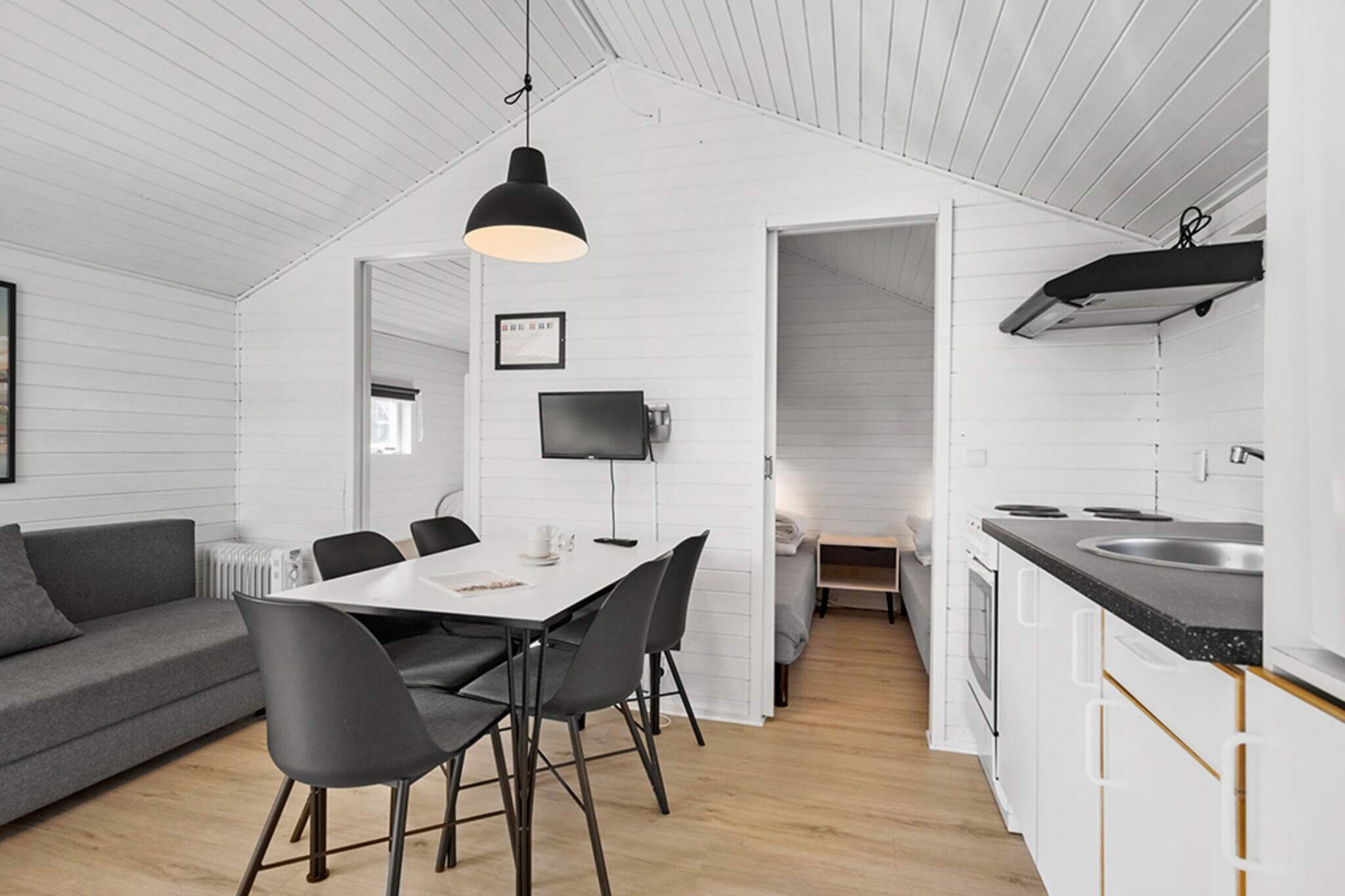 Kitchen(coffee machine, fridge), Living/bed room(double folding bed, TV), bedroom(double bed), bedroom(bunk bed), bathroom(washbasin, shower, toilet), sauna(shared with other guests, indoor, heated), heating(central), terrace, garden furniture, BBQ, parking, swimming pool(shared with other guests, indoor), play equipment, football goal