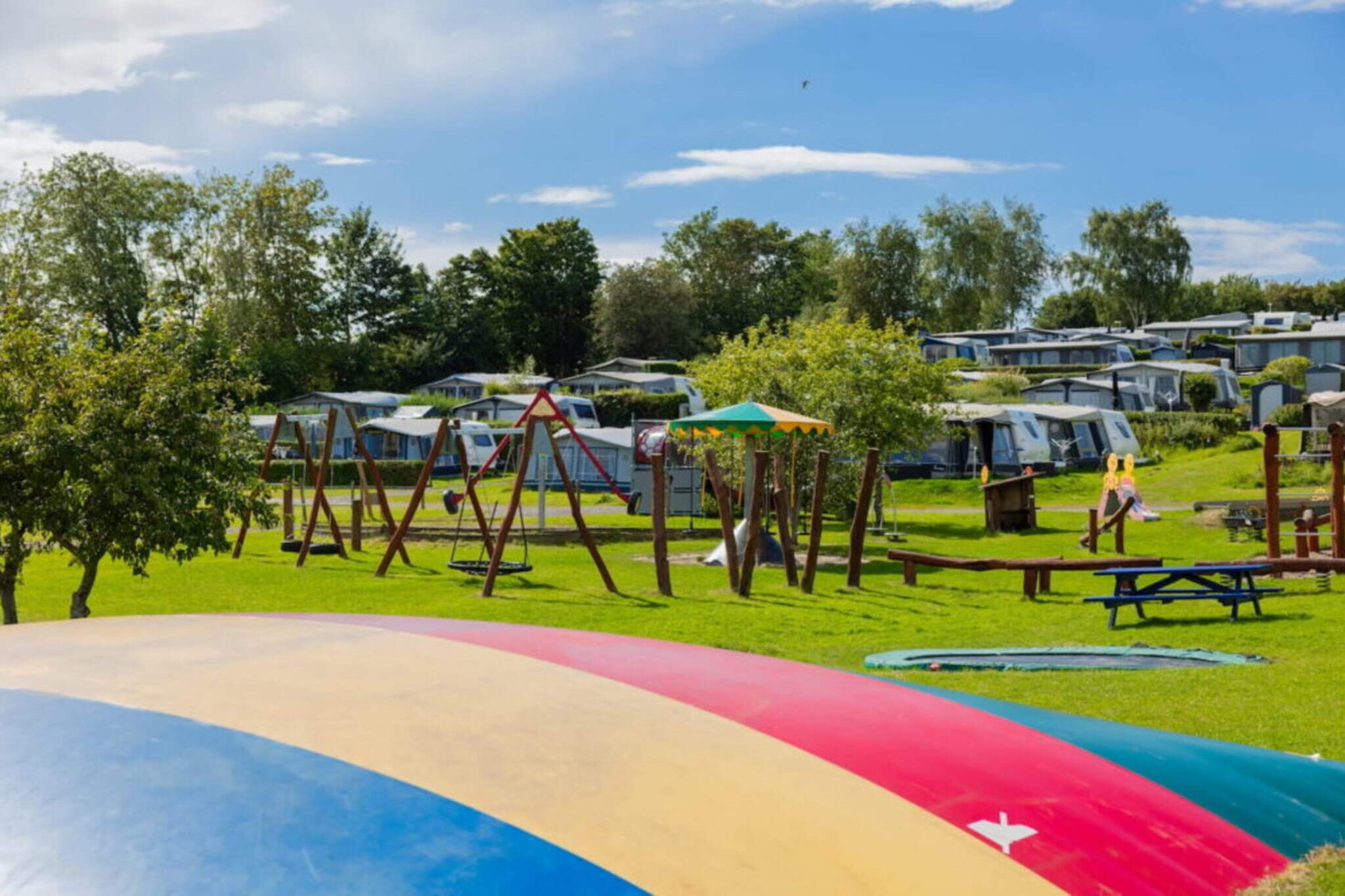 Kitchen(coffee machine, fridge), Living/bed room(double folding bed, TV), bedroom(2x single bed), bedroom(2x single bed), bathroom(washbasin, shower, toilet), heating(central), garden furniture, BBQ, parking, swimming pool(shared with other guests, outside), play equipment, football goal