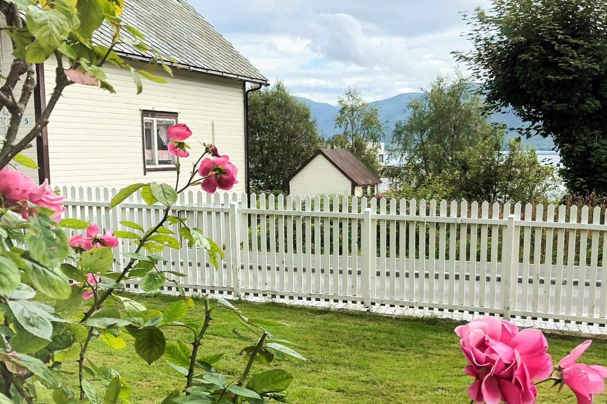 Lovely holiday home for the whole family by the sea in the idyllic village of FiskÃ¥. A great view of the Vanylvsfjord, a landscaped garden and lovely rose trees. A quiet and peaceful place where you can calm down and enjoy life. The holiday home has 3 floors and was renovated in 2020. On the ground floor, there is a separate kitchen and spacious living and dining room with access to a large, partially covered terrace. On the second level there are 3 bedrooms; 2 double and one single room. One double bedroom in the basement with access to the garden. The holiday home has an air-to-air heat pump and a wood-burning stove. 2 bathrooms, one with bathtub and one with shower. Free wireless internet with 150 fiber for international and Norwegian TV channels. Swimming opportunities from the wharf w/bathing stairs and the beach only 50 m away. The holiday home is located in FiskÃ¥ town with a short distance to a grocer and restaurant. This is the old sheriff's house in FiskÃ¥. Not far away (approx. 12km) you find the stairs Hakalletrappa with its first 600 hundred steps built with the help of Sherpas to the first viewpoint. The stairs will be extended to 2,000 steps towards the top Kragsethornet (458 m.a.s.l.) with panoramic views. An hour's drive away is the art nouveau city of Ã…lesund, known for the Aksla viewpoint, the Atlanterhavsparken aquarium and many shops and eateries. The bird mountain Runde is also a popular destination. Perfect for day trips by car to Vestkapp (Norway's westernmost point), Geiranger and Loen skylift in Loen Briksdalsbreen, also located in the area. Minimum of 14 days rental. A 15-foot rowing boat for rent.