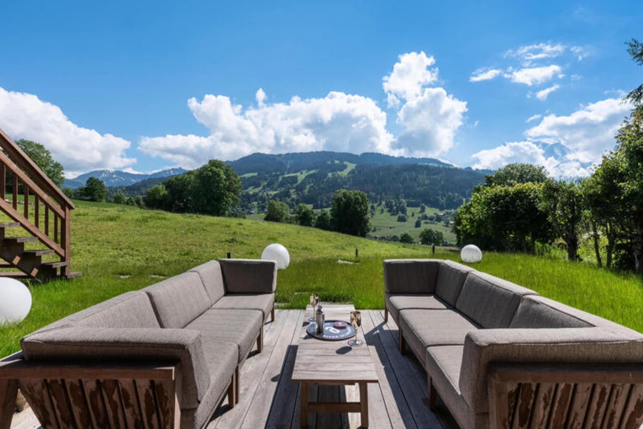 This newly built chalet in Megève/Combloux offers an exceptional mountain retreat with stunning views of Mont Blanc. Designed with modern elegance and warm décor, it provides the perfect blend of comfort and luxury for both summer and winter stays. Spread across three levels, the chalet includes a relaxation area featuring a heated indoor pool, hammam, and Italian shower. The lower level also has a garage with ski racks, a boot dryer, laundry facilities, and three double bedrooms, each with en-suite shower rooms and direct access to the terrace. 

Guests enjoy exceptional services, including regular cleaning, bed linen, and mid-stay linen changes. Located just a short drive from the heart of Megève and Combloux, guests can easily explore the surrounding ski areas and enjoy a wide range of mountain activities, making it an ideal destination year-round.

The first floor boasts a cinema room with a Sonos system, a spacious living room with a fully equipped kitchen, and a bar area with a wine cellar. The master bedroom offers a king-size bed, a dressing room, a bathroom with a shower and bathtub, and access to the main terrace. The second floor features an additional bedroom with twin beds and a desk, making it perfect for a quiet workspace.

