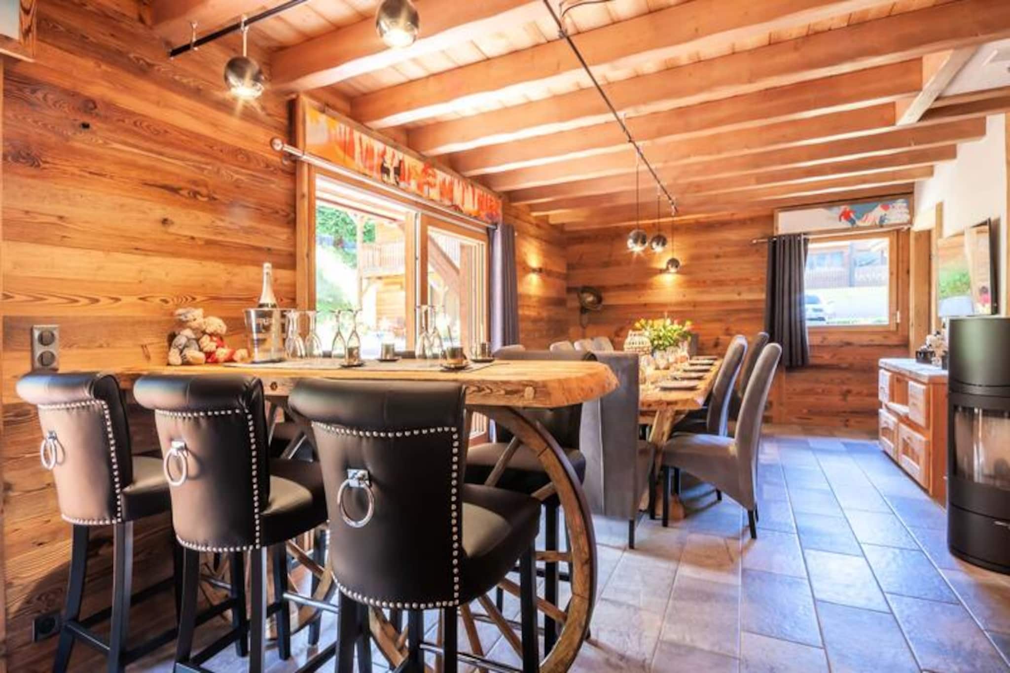 This magnificent new high-end chalet offers spacious and luxurious accommodation, ideal for up to 10 people. The property includes five bedrooms, with a mix of double beds and single bunk beds, each room equipped with a TV for added convenience. There are also two additional sleeping spaces, one in a mezzanine sleeping area and the other in a double bedroom with an en-suite. The chalet provides an array of amenities, such as a large terrace with access to a jacuzzi, a ski room with a boot dryer, and a relaxation lounge with a sauna. Free Wi-Fi, cable, satellite, and Netflix are available for entertainment, and the living areas are heated by a pellet stove. The property is pet-friendly, offering an outdoor space where pets can roam freely, though smoking is not permitted inside.

The chalet is conveniently located along the road to La Plagne, just a short 10-minute walk from the shops and with easy access to the center and ski lifts. It is also situated on the free shuttle line connecting guests to Super Morzine and Pleney, making it easy to reach popular ski areas. The chalet is ideal for winter and summer holidays, with the Summer Multipass offering discounts on local activities. Visitors can also enjoy nearby attractions, and with ample parking spaces, guests can easily explore the surrounding region by car.

The well-equipped kitchen opens onto a spacious dining area, with modern appliances such as a raclette machine, fondue set, and a stone grill for cooking. In addition, a BBQ is provided for outdoor cooking during warmer months.