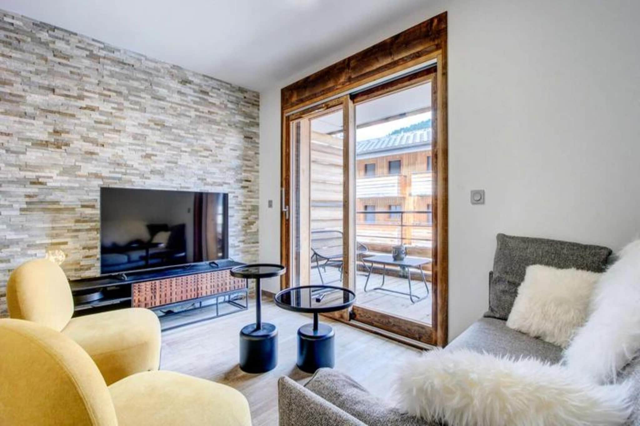 Property, along with its spacious design, offers a comfortable two-bedroom apartment with a cabin area, ideal for up to 6 guests. The 60m² layout features a living room with an open kitchen, dining area, and sitting area, all opening onto a balcony with views of the village. The sleeping area includes two single bunk beds, while the two bedrooms offer flexible sleeping arrangements with either a double bed or two single beds. The apartment provides essential amenities such as heating, bed linens, and towels, with beds made on arrival. Mid-stay and end-of-stay cleaning are included in the rental. The property does not allow pets, and bicycles are not permitted inside the apartment. Guests can enjoy access to a ski/bike cellar with a boot dryer and a private parking space in the basement (small car recommended due to narrow access). 

Located in the heart of the village, this property offers direct access to the slopes of the Morzine-Les Gets ski area, making it ideal for skiing enthusiasts. Guests can enjoy the lively atmosphere of the village with easy access to local shops, restaurants, and cafés. In the summer, the Summer Multipass offers guests access to a variety of outdoor activities. The residence is well-connected with public transportation options, including bus and train stations, and the nearest airport is a short drive away, ensuring convenient arrival and departure for travelers.

The apartment’s open kitchen is fully equipped with essential appliances, including a microwave and dishwasher, offering the convenience of preparing meals during your stay. The living area, with its comfortable sitting area, provides a relaxing space to unwind after a day on the slopes. Additional amenities include two modern shower rooms with WC facilities, ensuring comfort and convenience for all guests. For secure storage, the property offers a ski/bike cellar, and the private parking space, though narrow, provides secure parking for one vehicle.