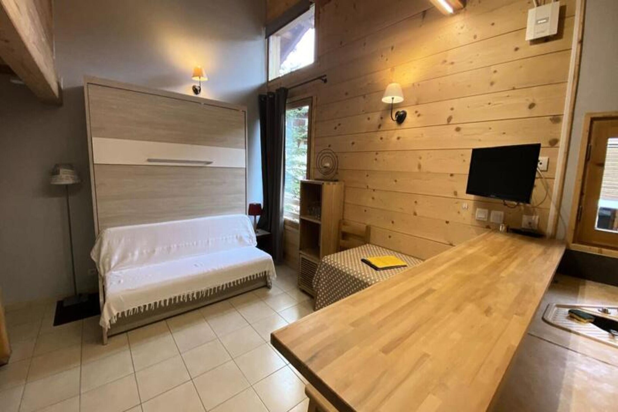 Property along with its charming and modern design offers a comfortable base for a mountain vacation. The apartment is designed for up to four people, featuring a living room with a 160 cm foldaway bed, an open, fully equipped kitchen, and a separate bedroom with two single beds. Additionally, there is a bathroom and a separate toilet for convenience. The residence includes a parking space, ensuring ease of access to the property. While the apartment is rated with a 3-star classification, it is not accessible to individuals with reduced mobility. Services such as end-of-stay cleaning are included in the rental, while bed linen and towels are available at an extra cost.

Located in the heart of the Vars Risoul area, the apartment is ideally positioned close to all essential amenities. It’s a short distance from the ESF ski school, making it convenient for those eager to hit the slopes. The residence is also within walking distance of local shops, restaurants, and the tourist office, ensuring guests have everything they need within reach. The proximity to the ski lifts and the vibrant village atmosphere provides guests with the ideal setting for both relaxation and adventure during their stay.

In terms of amenities, the apartment is well-equipped for a self-catered stay with a functional kitchen. Though bed linen and towels are not included, they can be arranged for an additional fee. Other essential services such as heating and end-of-stay cleaning are provided, adding to the apartment’s overall convenience. Additionally, tourist taxes and a credit card deposit will be collected upon arrival, ensuring a smooth check-in process. The apartment’s modern design and proximity to various attractions make it an ideal choice for those seeking both comfort and accessibility during their mountain getaway.