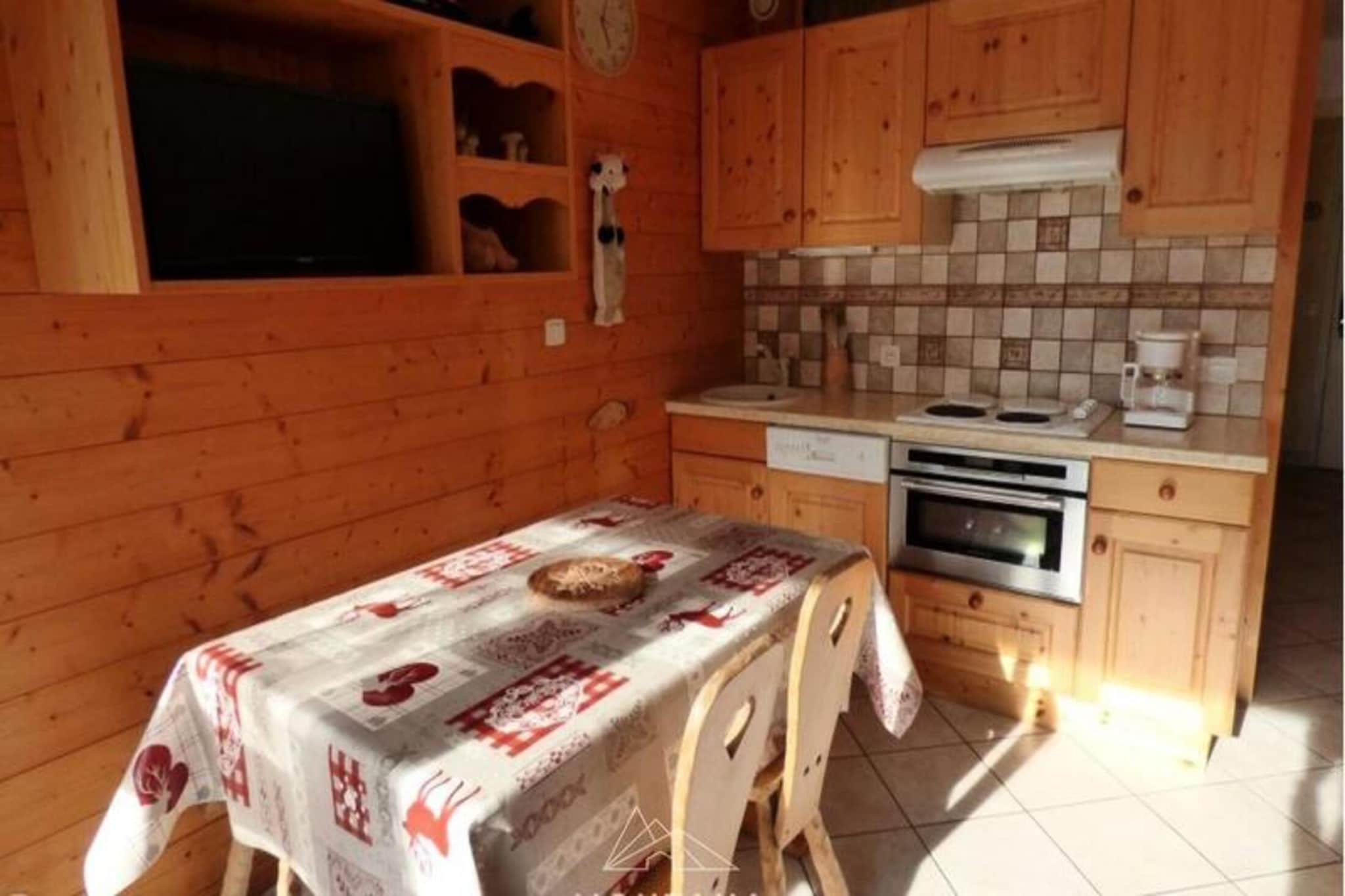 Property, along with its cozy charm, offers a well-equipped holiday home for up to 5 people. It features a living room with a BZ sofa bed, a cabin bedroom with a double bed, and a single wagon bed in the entrance area. The south-facing balcony adds extra comfort, while additional rentals for sheets and towels are available. Pets are not allowed, and the accommodation is conveniently located near a ski bus stop, just 1000 meters from the cable cars.

Located in the peaceful Hameau de Suize area, the property offers easy access to Les Aravis’ trails and outdoor activities. It is 32 km from Annecy SNCF station and 52 km from Geneva Airport, providing convenient travel options for visitors. Guests can also enjoy nearby amenities, including shops, restaurants, and ski equipment rentals, making it an ideal base for exploring the area.

The kitchen is fully equipped with essential appliances, including a fridge, microwave, and hob. A shower room with WC, ski storage, and electric heating ensure comfort throughout your stay. This well-appointed holiday home is perfect for a relaxing yet active getaway in the Alps.