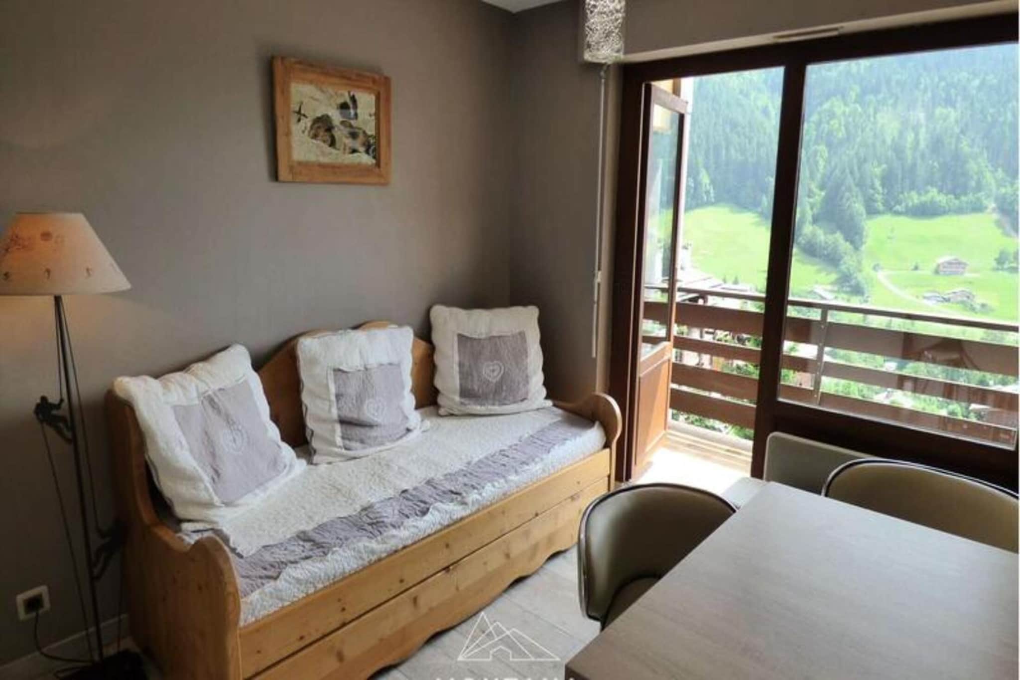 This beautifully renovated 20 m² studio is ideal for up to 4 people and is located in the Nant Robert area, just 5 minutes by car from the center of the village and shops. The apartment offers a south-west facing balcony with stunning views of the village and the surrounding Aravis mountain range. Inside, the studio features a double bed (140 cm) in the sleeping area, a living room with a 2x80 pull-out sofa, and a shower room with a WC. 

The apartment is situated on the first floor (fourth from the foot of the residence) and is rated 2 stars for 2 people. Guests can enjoy the peaceful setting and scenic views, while being close to the village amenities. Sheets and towels are not provided, and tourist taxes are payable for adults (18+ years).

The property is conveniently located with easy access to transport links: Annecy SNCF train station is 32 km away, Geneva Airport is 52 km, and Lyon Airport is 155 km.