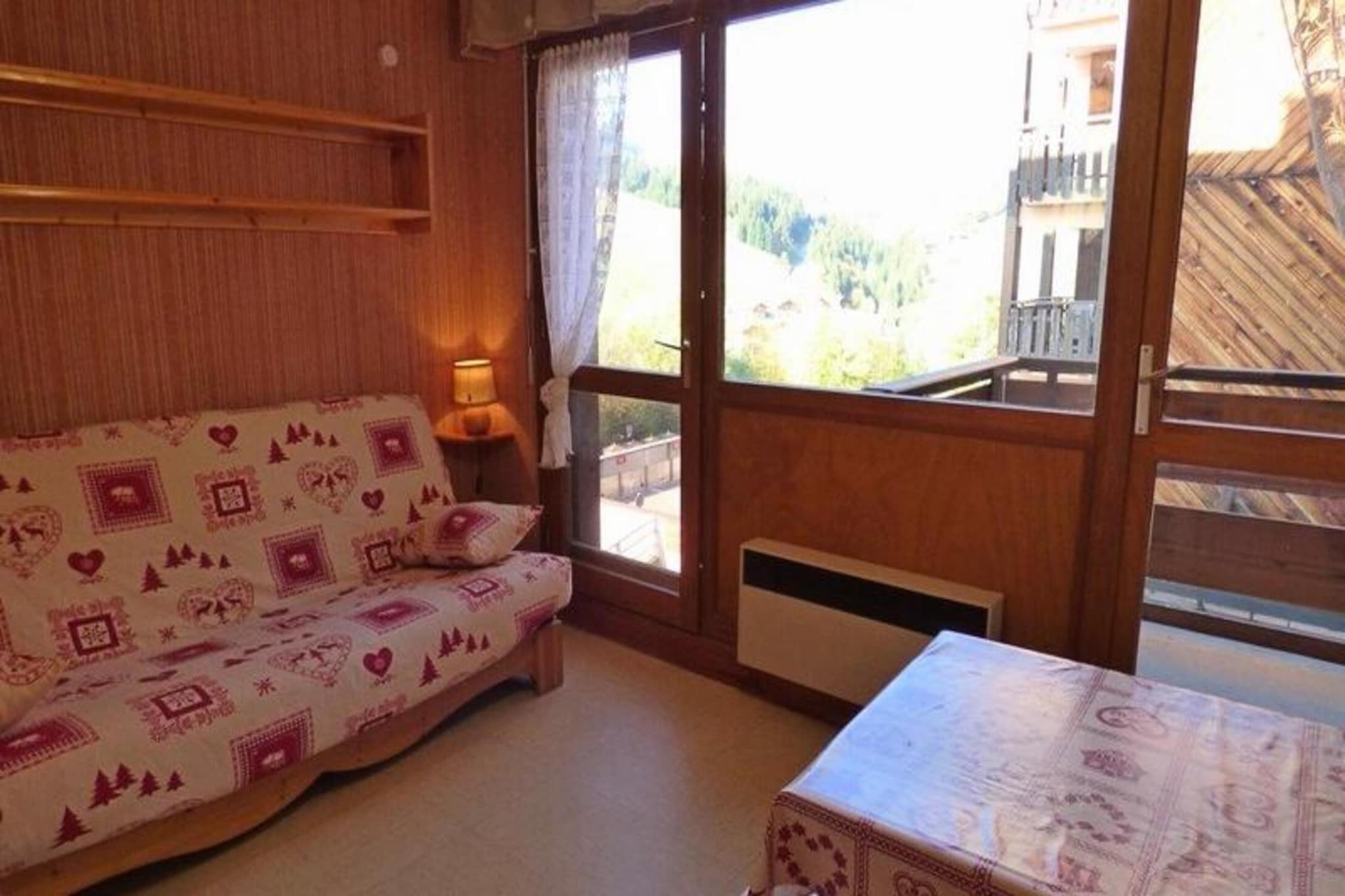 This pleasant studio apartment, ideal for up to 4 people, is located on the 1st floor of a chalet in the peaceful Samance district at the top of the Chinaillon resort. Offering an incredible view of the surrounding ski area, the studio includes a cozy living space with a 140 cm sofa bed, a mountain corner with 2 single bunk beds, and a fitted kitchen open to the living room. It also features a bathroom with a shower and WC, and a balcony with eastward exposure to enjoy the morning sun. Covered parking is available for guests.

The apartment is located 32 km from Annecy SNCF train station and 52 km from Geneva Airport, making it easily accessible for travelers from different regions. Additionally, Lyon Airport is 155 km away, providing further connectivity. The location offers a quiet and scenic setting, perfect for relaxing after a day of skiing or exploring the local area. Please note, there will be construction work planned nearby during the summer of 2023.

Additional services such as sheet and towel rental are not included, and tourists are required to pay applicable local taxes. This accommodation is designed to offer a comfortable stay with all essential amenities, ideal for small groups or families looking to enjoy the beauty of the mountains.