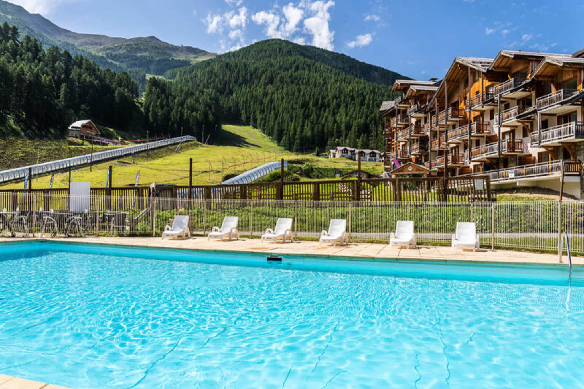 Property, along with its prime location, offers a variety of comfortable accommodations designed to host between 4 to 10 people. The units are thoughtfully furnished with either mountain-inspired décor or modern designs and include balconies or terraces to enjoy the surrounding views. The apartments feature spacious living areas, often including a 2-seater pull-out sofa bed and television for relaxation. Guests have access to a private ski box, ensuring easy ski-in and ski-out access. The accommodation also offers convenient rental options and has a heated outdoor swimming pool (seasonal availability) and saunas, providing excellent relaxation options for guests.
The vacation home is ideally located at an altitude of 1,800 meters, forming the heart of the resort. It is conveniently situated near shops, bars, and restaurants, ensuring that guests have everything they need for a pleasant stay. The property offers direct access to the snow front and ski slopes, making it a perfect choice for ski enthusiasts. Additionally, it is well-connected with transport options, though exact details about nearby airports, buses, and train stations were not provided, making it important to plan transportation in advance for those traveling from farther destinations.
The apartment features a fully equipped kitchen, including essential appliances such as a dishwasher, toaster, kettle, and coffee maker, ideal for preparing meals during your stay. The bathroom is fitted with a bathtub, offering a relaxing space to unwind after a day of activities. The bedroom configurations include a double bed and two single beds, ensuring flexibility in sleeping arrangements for families or groups. Whether enjoying the nearby slopes or relaxing in the cozy interior, this property is designed for comfort and convenience.