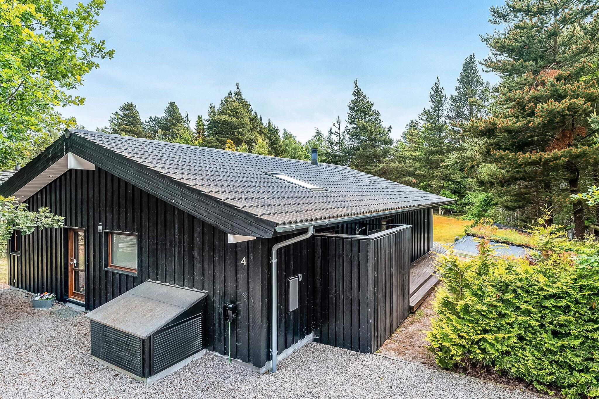 Modern, top-class vacation home in the second row to one of Denmark's best and most child-friendly beaches. This beautiful and unique house, built in 2016, is 98 m2 and, in addition to its superb location, is bright and stylishly furnished with, among other things, an indoor spa and sauna.The house welcomes you into a spacious entrance hall, from which you have access to a good-sized bathroom with sink, toilet, shower, and closet space. Furthermore, in the entrance hall/distribution corridor, there is both a dryer and a washing machine. In addition to a toilet, sink, and shower, the cottage's second bathroom also has a spa and sauna.The cozy living room is combined with a modern kitchen, which includes induction hobs, a separate oven and microwave, refrigerator, dishwasher, 1-59 l freezer, and coffee maker. The window facade provides beautiful daylight to the living room and dining table. The living room has a smart TV, Bluetooth, wood-burning stove, and wireless internet. There is underfloor heating throughout the house, which is heated by an energy-efficient air/water heat pump. There are three bedrooms: one with a double bed and two with two single beds. There is also a loft with two mattresses and a TV with Chromecast.The cottage is located on a beautiful 927 m2 natural plot, so there is plenty of space for play and games in the garden. For younger guests, there is a sandbox and swing set. On the side of the house, there is an outdoor shower, which is perfect for rinsing off after a trip to the beach.Enjoy the sun on the terrace in the garden furniture or in the sun loungers, and as evening approaches, you can extend the evening's cosiness under the covered terrace while conjuring up a delicious meal on the gas grill.There is a charging station for electric cars Type 2-IEC 62196-2Not available for rental to youth groups.A refundable deposit might be charged closer to your check-in date. The security deposit ensures a smooth stay and covers any additional services or consumption charges.This deposit covers utilities consumed during your stay and any additional services that may be taken.The final amount will be adjusted based on actual meter readings, actual usage of extra services, and any remaining balance will be refunded within 21 days after checkout.This deposit simply acts as a prepayment for charges that  you would anyways pay for, ensuring a seamless stay and check-out experience.