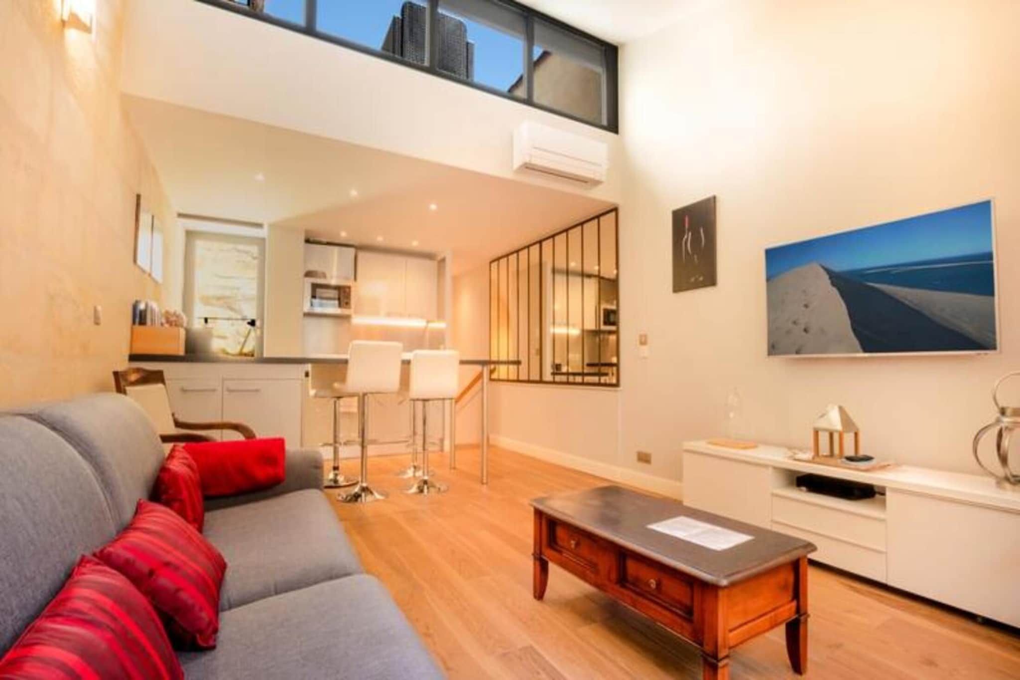 This recently renovated duplex offers an ideal blend of modern comfort and historic charm, situated in the heart of Bordeaux. Located on the first floor of a beautiful stone building, the apartment accommodates up to four guests and is perfect for those seeking a tranquil yet central base to explore the city. The loft-style living space features exposed stone walls and large glass windows that bathe the apartment in natural light. The living area includes a cozy TV corner with a sofa bed, a bar table, and stools, along with a fully equipped kitchen for preparing meals.
The bedroom, located on a single level, offers a comfortable double bed (140 cm) and direct access to a stylish bathroom with a walk-in shower and vanity unit. One of the standout features of the apartment is the private rooftop terrace, which provides stunning views of the Bordeaux rooftops. The terrace is equipped with a sofa and two armchairs, making it the perfect spot to enjoy breakfast or unwind with an aperitif in the sun after a day of sightseeing.
The apartment is ideally located for those wanting to explore Bordeaux’s rich history and vibrant culture. Just a short walk away, you’ll find iconic attractions such as the Place de la Bourse, the beautiful waterfront along the Garonne River, and the magnificent Palais Rohan. Additionally, the city’s renowned wine bars and cafes are within easy reach, allowing you to indulge in Bordeaux's exceptional culinary scene. Public transport options, including tram and bus stops, are nearby, making it convenient to get around and discover more of this UNESCO World Heritage city.