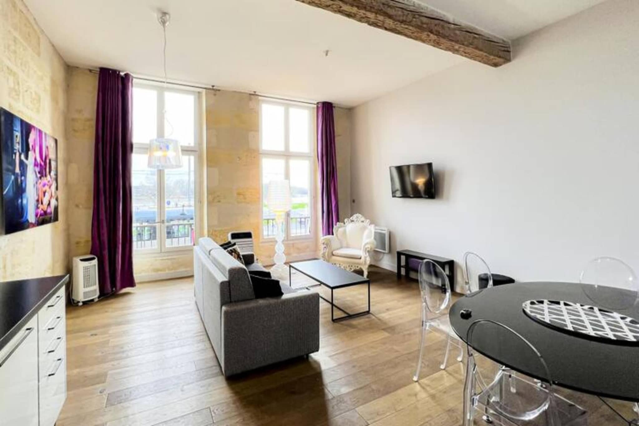 This charming 72 m² furnished apartment offers a comfortable and stylish retreat in the heart of Bordeaux, located in a beautiful stone building with views of the Garonne River. Situated on the first floor, without an elevator, the property comes complete with a parking space at the nearby Cité Mondiale car park. Its central location provides easy access to Bordeaux’s top attractions, including the renowned Museum of Contemporary Art (CAPC) and the picturesque quays along the river, just steps away. The nearby Tram B station makes it simple to explore the city’s vibrant neighborhoods at your leisure.

The apartment is thoughtfully designed with a spacious living room featuring a sofa, two armchairs, a coffee table, and a TV, all connected to a dining area with a table for six. The open kitchen is fully equipped with modern appliances such as an oven, microwave, dishwasher, fridge, hotplates, kettle, Nespresso coffee maker, and toaster. It’s perfect for preparing meals during your stay. The property includes two cozy bedrooms: one with a double bed (160 x 200 cm) and a chest of drawers, and the other with two single beds (90 x 200 cm) and a wardrobe. The shower room is fitted with a sink, towel dryer, and WC.

The apartment also comes with useful amenities such as a washer-dryer, iron, hairdryer, and household linens, with beds made upon arrival. The stylish yet practical space ensures a comfortable stay in one of Bordeaux's most iconic locations, with easy access to local shops, restaurants, and the scenic beauty of the Garonne.






