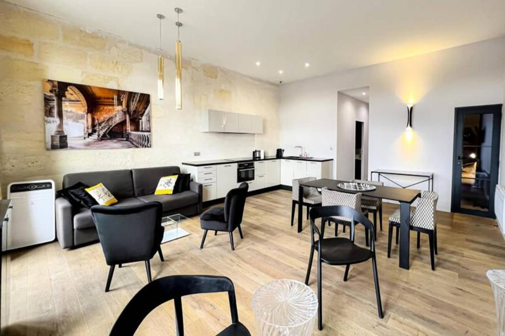 This 72 m² furnished apartment comfortably accommodates up to 6 people. It features one bedroom with a 160 x 200 cm double bed and another bedroom with two 90 x 200 cm single beds. The spacious living room includes a sofa bed, two armchairs, a coffee table, and a TV, providing ample space for relaxation. The apartment is pet-friendly, and household linen (sheets, towels, and tea towels) is provided, with beds made upon your arrival. While there isn't a balcony, guests will enjoy the convenience of a fully equipped open kitchen, air conditioning, and Wi-Fi. Additionally, a private parking space is included, with extra rental options like a late check-in service available upon request.

Located in the center of Bordeaux, the apartment is just a short walk from the famous Museum of Contemporary Art (CAPC) and the scenic Garonne River quays. It is also conveniently situated near the tram (Tram B) that provides easy access to Bordeaux’s vibrant city center. The city’s famous wine region, UNESCO-listed landmarks, and cultural attractions are all within close proximity. Bordeaux’s train station is just a 10-minute walk away, with buses and tram stops nearby. Guests can reach the Bordeaux-Mérignac Airport in 30 minutes by transport, making this apartment an ideal base for exploring both the city and surrounding attractions.

The apartment offers a fully equipped kitchen with modern appliances, including an oven/microwave, dishwasher, fridge, hotplates, kettle, Nespresso coffee maker, and toaster. For added convenience, the apartment is equipped with a washer dryer, iron, and ironing board. The bathroom features a shower, sink, towel dryer, and WC. The apartment is designed with all the essentials to make your stay comfortable, and a secure 750-euro deposit is required for reservations.