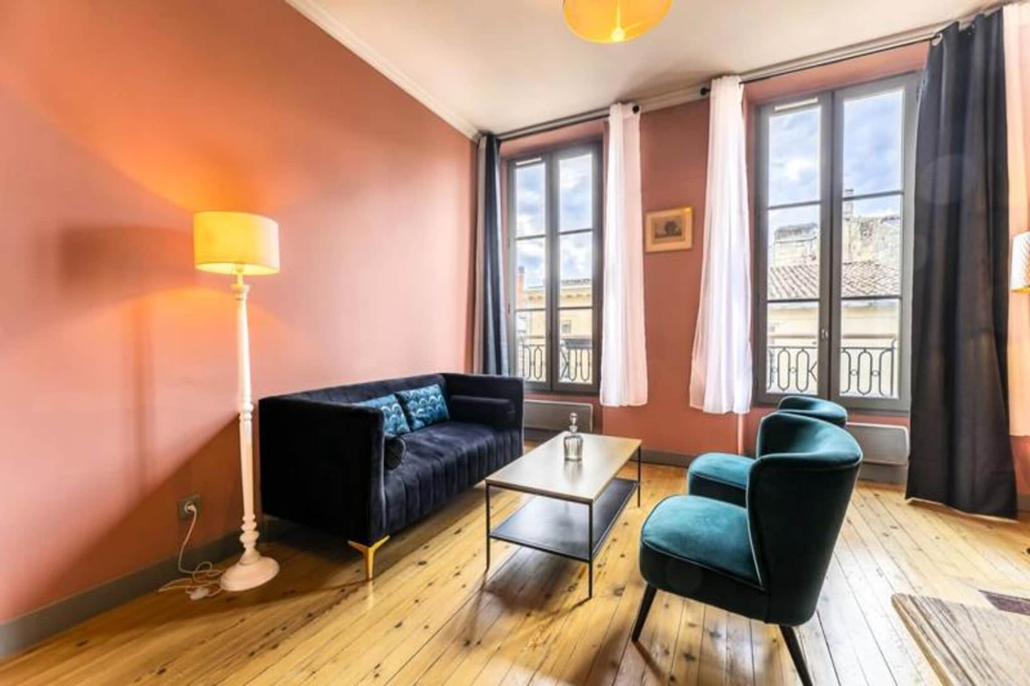 This beautifully furnished 85 m² apartment is located in the heart of Bordeaux, offering a luxurious and comfortable stay. Situated on the third floor of a classic Bordeaux building, the apartment has been meticulously renovated and combines modern comforts with traditional charm. The spacious living room, with its southern exposure, is flooded with natural light and features elegant furnishings, including a cozy sofa, armchairs, and a beautiful fireplace. The open-plan kitchen and dining area are perfect for enjoying meals with a group, and the apartment boasts two stylish bedrooms. The first bedroom features a queen-size bed with a private bathroom that includes a walk-in shower, while the master bedroom has a queen-size and a single bed, as well as an en-suite bathroom with a bathtub and walk-in shower.

Located just steps from the iconic Place Gambetta and Cours de l'Intendance, this apartment places you in an ideal spot to explore Bordeaux's major attractions on foot. The area is known for its chic atmosphere, with luxury boutiques, fine dining restaurants, and performance halls. Nearby, you’ll find the grand Place des Quinconces, the elegant Grand Théâtre, and the historic Saint-André Cathedral with its towering Pey-Berland Bell Tower. Whether you’re exploring the Golden Triangle, enjoying the local wine culture, or taking a stroll along the river, this location ensures you're immersed in the vibrant culture and history of Bordeaux. A dedicated parking space in the nearby public Auditorium car park ensures convenience during your stay.