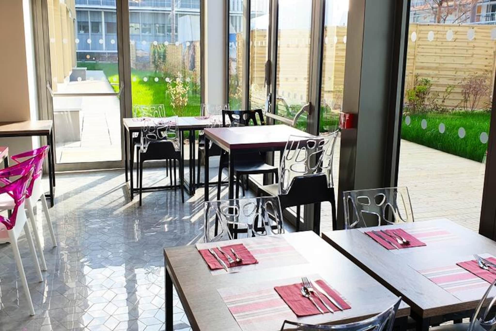 This modern and comfortable residence is situated in the heart of the Bordeaux Ginko eco-district, offering a perfect blend of urban and natural settings. Just 50 meters from shops, restaurants, and amenities, it is conveniently located near the Parc des Expositions, Palais des Congrès, Stade Matmut Atlantique, and Lac de Bordeaux. The residence features 97 spacious, bright, and air-conditioned apartments, with options ranging from studios to larger apartments. Some rooms come with a terrace, and the property offers various on-site facilities, including a fitness room, breakfast area with a tree-filled patio, and laundry services.

Guests can enjoy nearby attractions, including the Calicéo aquatic fitness center with over 4,000m² of wellness and leisure facilities. The lake beach and surrounding parks provide a serene escape, while the nearby tram line C offers easy access to the city center and train station. For sports fans, the Stade Matmut Atlantique is within walking distance, and the area is also home to scenic pedestrian paths and shopping areas. 

Public parking is available nearby, and pets are welcome for an additional fee. This location is ideal for both business and leisure travelers seeking comfort and convenience in Bordeaux.