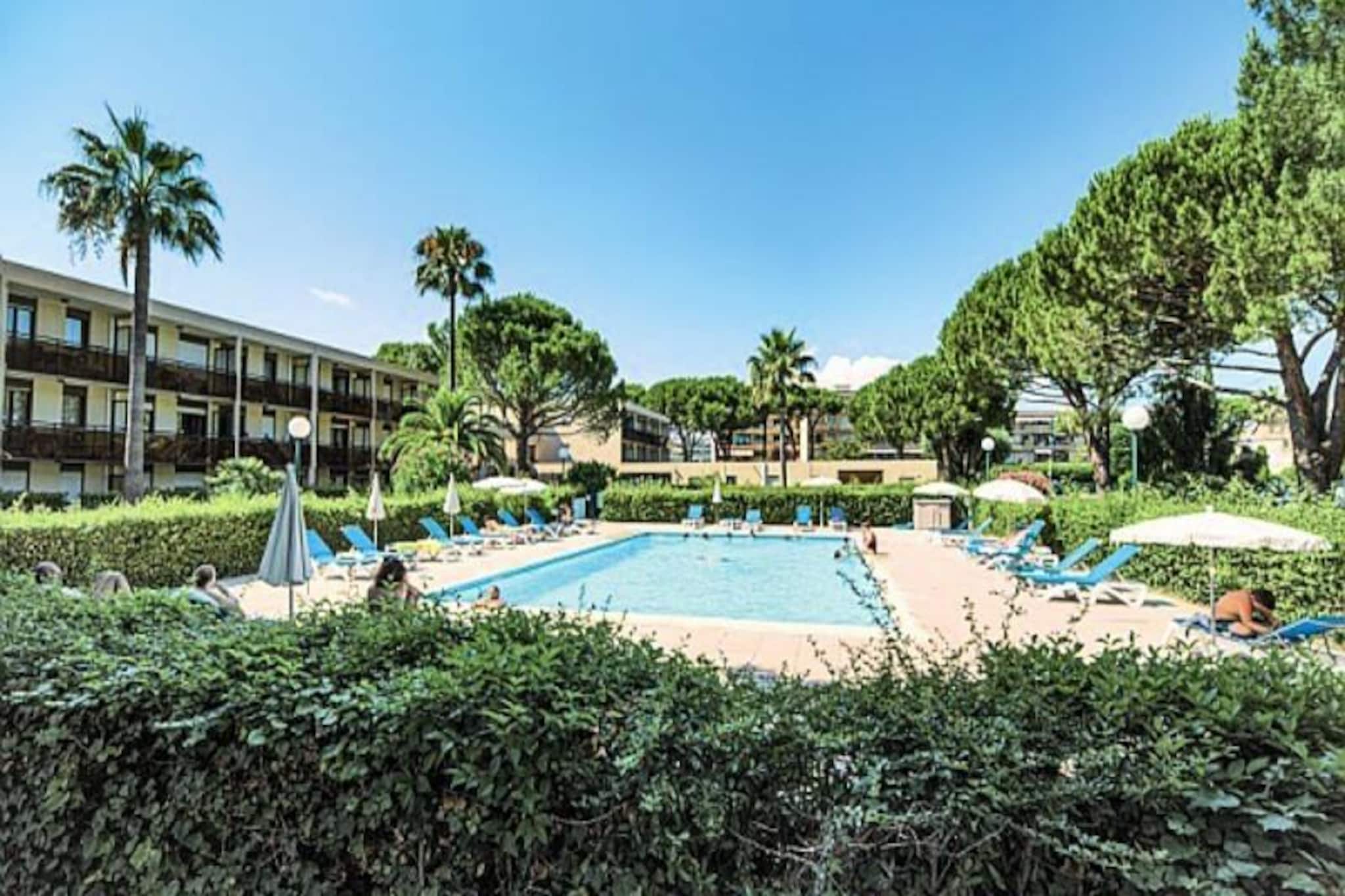 Situated in the heart of Mandelieu-la-Napoule, just at the gateway to Cannes, this delightful residence offers a perfect blend of city convenience and serene natural surroundings. Nestled within a lush, private garden, the property provides a peaceful retreat while being only 50 meters from shops and 1.5 kilometers from the sandy beaches. The residence features cozy, air-conditioned apartments, designed for comfort and labeled Clé Verte for its commitment to ecological tourism. Guests can enjoy a private covered terrace and limited on-site parking for added convenience.
The property boasts an inviting outdoor swimming pool, available from April to mid-October, providing a refreshing escape for residents (additional charges apply). For the active-minded, nearby facilities offer golf, tennis, and even a pétanque ground, perfect for trying out this beloved local pastime. The accommodation includes a comfortable living area with a sofa bed, a semi-open kitchen, a cabin space with bunk beds, and a bathroom with modern amenities, ensuring a convenient and practical stay.
Its prime location provides easy access to the best of the French Riviera. Explore the charming town of Mandelieu-la-Napoule, known for its stunning Château de la Napoule, or take a short trip to Cannes for luxury shopping, fine dining, and the iconic Croisette. Nature enthusiasts will appreciate the proximity to Esterel Massif, ideal for hiking and outdoor activities. Whether you're looking for a peaceful escape or an adventure-filled getaway, this residence offers the perfect base to experience the Mediterranean lifestyle.
