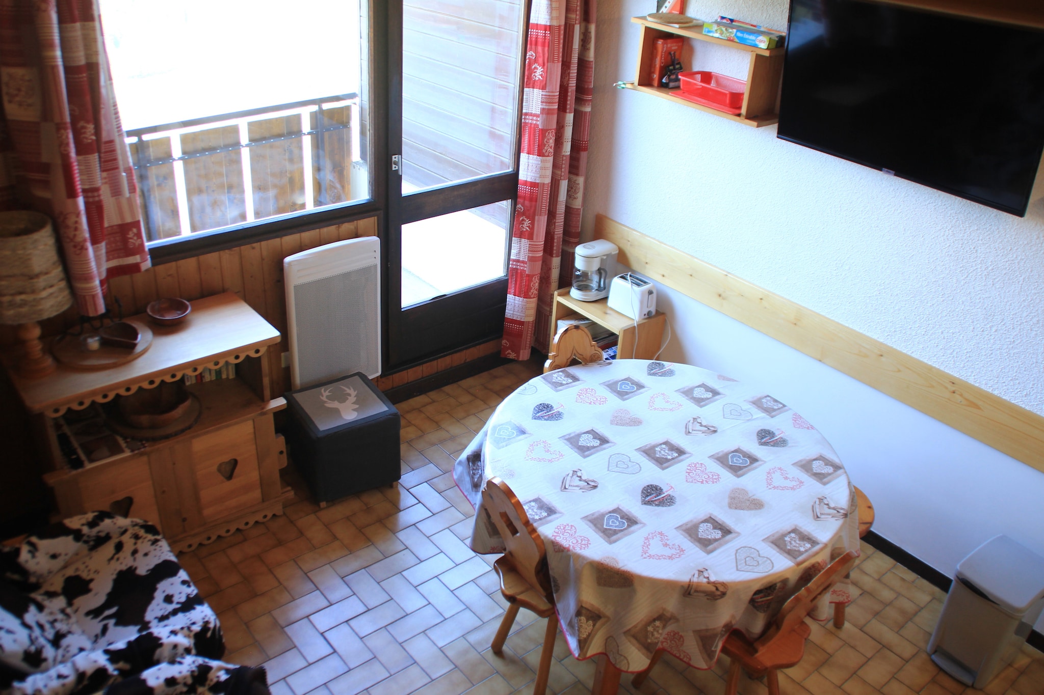 This charming apartment offers comfortable accommodations for up to six guests, ideal for families or groups seeking a mountain retreat. The space includes a double bed in the main bedroom, two single beds in a second bedroom, and a bunk bed on a mezzanine level. Guests can relax in the bright living room, complete with a flat-screen TV, or enjoy the south-west-facing balcony with picturesque views. A ski locker and covered parking space are provided for convenience. Please note that pets are not allowed, and optional services like bed linen, towels, and final cleaning can be arranged to enhance your stay.
Nestled in the Boude area of Chatel, this property is well-located for both skiing and exploring the village. The apartment is just 500 meters from the nearest chairlift, making it perfect for ski enthusiasts. A free shuttle bus stop nearby ensures easy access to local attractions, while shops and restaurants are within walking distance 1 km and 800 meters away, respectively. The central location in the Portes du Soleil region allows guests to experience a wide range of year-round activities.
The apartment is equipped with a modern kitchen featuring a vitroceramic hob, fridge, freezer, dishwasher, microwave, oven, coffee maker, kettle, and toaster, offering everything needed for meal preparation. The bathroom includes a shower and WC, ensuring comfort and functionality. With its serene mountain views, convenient amenities, and cozy interiors, this residence provides an excellent base for an unforgettable alpine getaway.
Note: The tourist tax will be collected at the property and is not a part of rental.