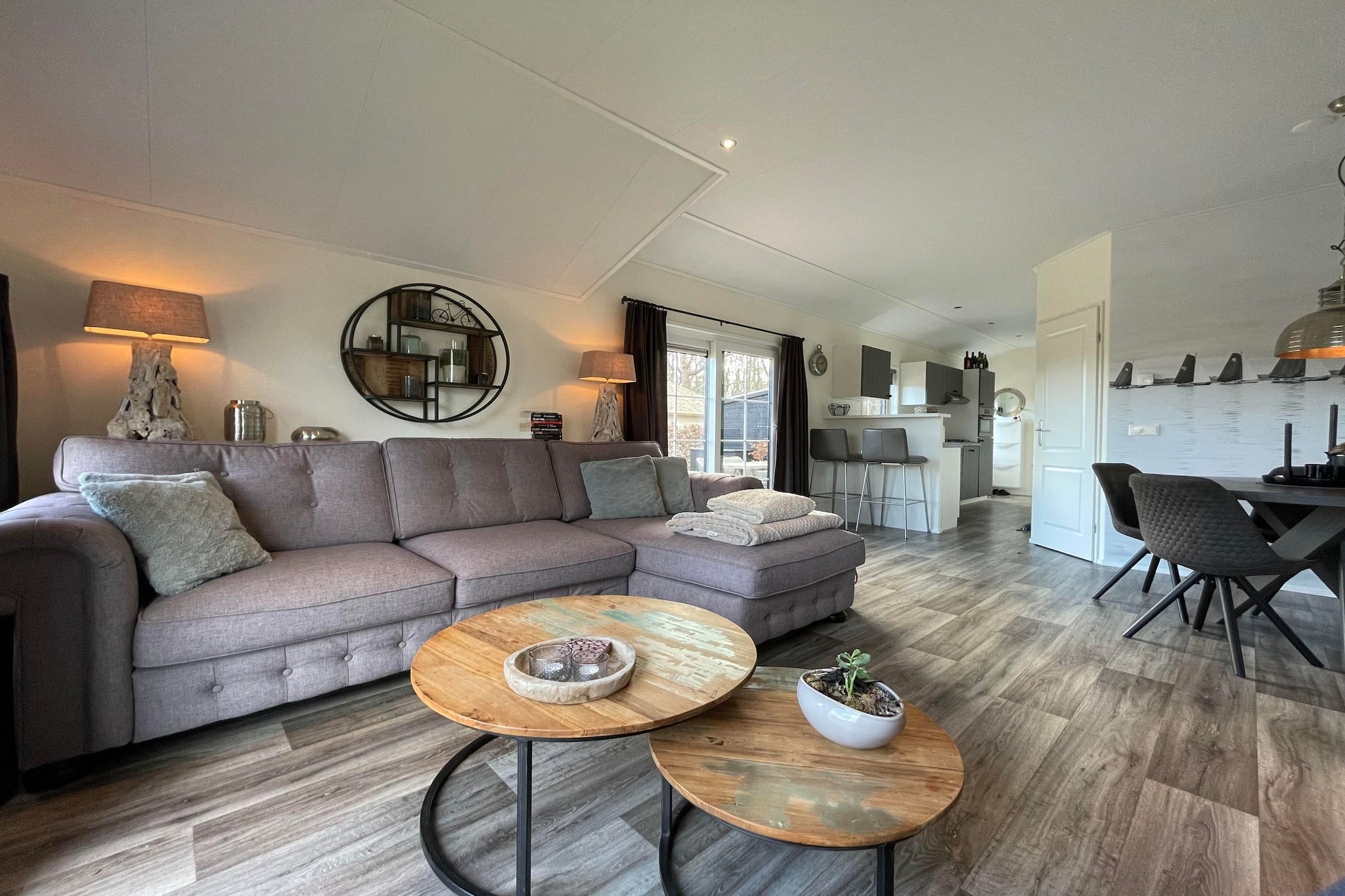 Nestled in the peaceful village of Sint Nicolaasga, this charming waterside chalet offers a serene escape in the heart of Friesland. Surrounded by tranquil canals and lush greenery, the chalet blends comfort with natureâ€”ideal for families, couples, and seniors looking to unwind. Step outside to your private terrace with garden furniture, perfect for coffee by sunrise or an evening drink under the stars. The park features a pool,  play areas for children, and bike rentals just 10 meters from your door, making it easy to explore nearby landscapes like the Langweerderwielen and Sneekermeer lakes.

Set on a scenic estate with direct access to the water and forest, itâ€™s also a paradise for many, with long walking paths, lakeside trails, and even nearby beaches like Lemmer. Just minutes away lies the historic St. Nicolaaskerk, an iconic Catholic church housing 16th-century relics, standing tall in the village skyline. Time your visit with Sint Nykster Merke, the beloved three-day fair in early September, filled with parades, games, and local festivities. 
For something truly memorable, take to the skies with Dreamflights, offering hot air balloon rides over the sparkling Friesland waters and countryside. After a day of adventure, dine at local gems like Brasserie No.14 or enjoy fresh lakeside cuisine at â€™t Vlasblom in nearby Langweer. 
Whether you're here for nature, history, or a peaceful getaway, this lakeside chalet offers the best of Friesland in every season