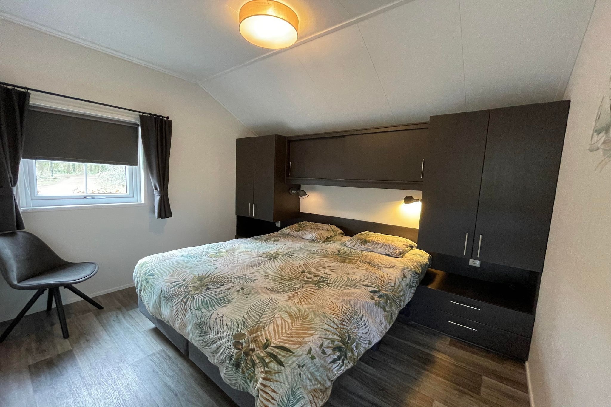 Ground floor: (Living room(TV, seating area), open kitchen(electric kettle, coffee machine, combination microwave, dishwasher, fridge), bedroom(bunk bed), bedroom(double bed), bedroom(single bed, single bed), bathroom(shower, washbasin, toilet))\n\ngarden doors, terrace, garden, garden furniture, parking