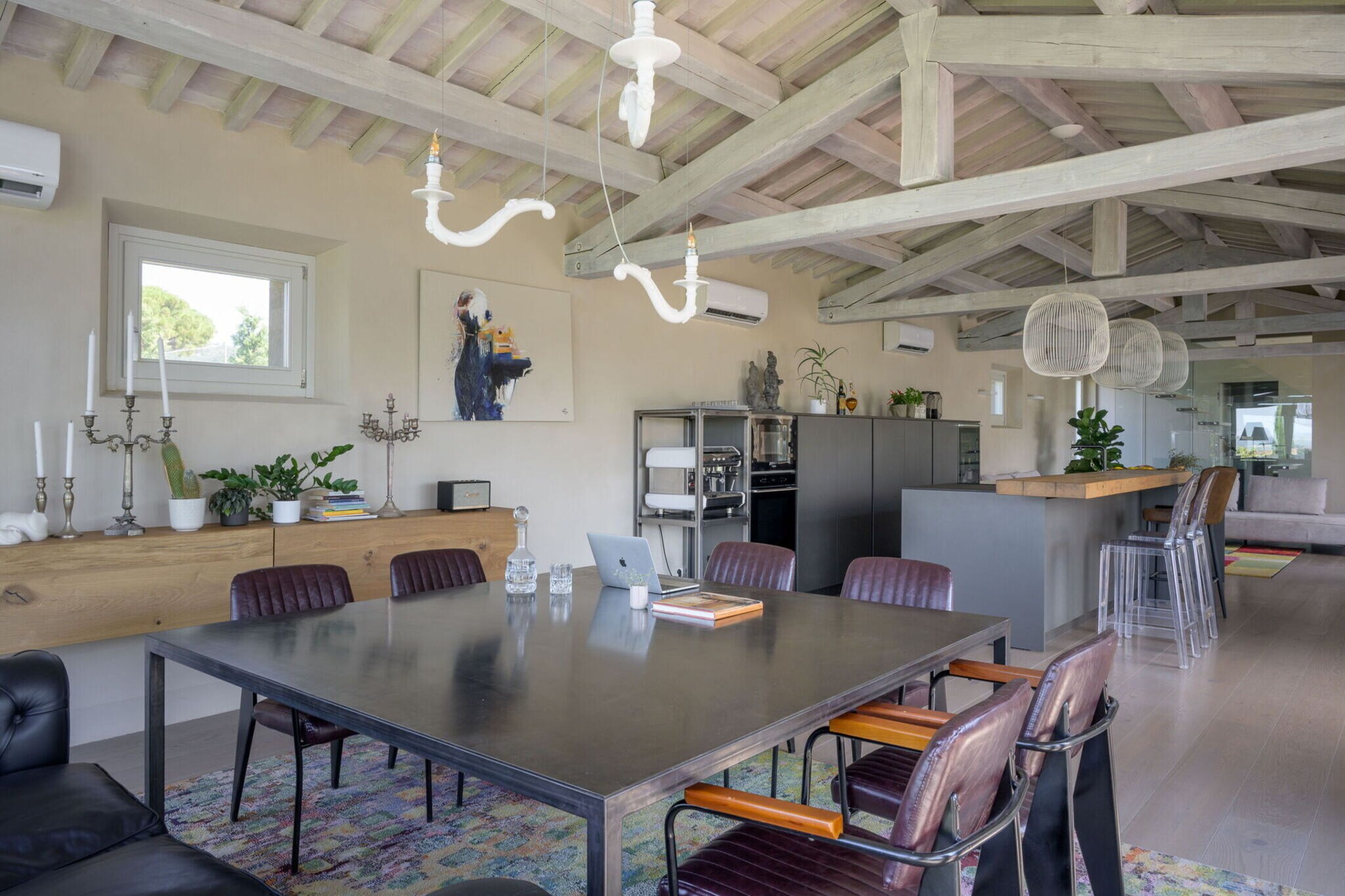 among the sun-drenched hills near Cortona, this stone-built villa perfectly balances eco-conscious design with refined contemporary luxury. Inside, you'll find clean architectural lines softened by warm wooden accents and thoughtfully curated décor. Panoramic windows seamlessly connect the indoors with the outdoors, inviting in views of the surrounding vineyards. A private infinity pool awaits in the beautifully landscaped garden, while the villa’s sauna, Turkish bath, and massage area in the basement create a private spa-like haven. Whether you're dining al fresco on the patio, enjoying the breakfast service indoors, or simply unwinding beneath the parasol, every moment here is designed for indulgent relaxation.
Just minutes away, the enchanting town of Cortona offers a journey into Tuscany’s storied past with its medieval streets, artisan boutiques, and spectacular hilltop vistas. Nearby, Montepulciano tempts wine lovers, while Pienza and Montalcino promise scenic day trips steeped in culture and local flavor. For golf enthusiasts, a pristine course lies just 11 km away, and Camucia or Terontola’s stations conveniently link you to Florence, Rome, and beyond. Yet, despite its prime location, the villa’s setting feels wonderfully secluded, ideal for restful afternoons under the Tuscan sun.
Dining nearby is a celebration of local tradition—within 2 km you'll find authentic trattorias and wine bars serving hand-rolled pasta, seasonal vegetables, and Chianti straight from the vineyard. For a memorable meal, head to Cortona’s La Bucaccia for its famed Florentine steak or enjoy sunset aperitivo at Osteria del Teatro.