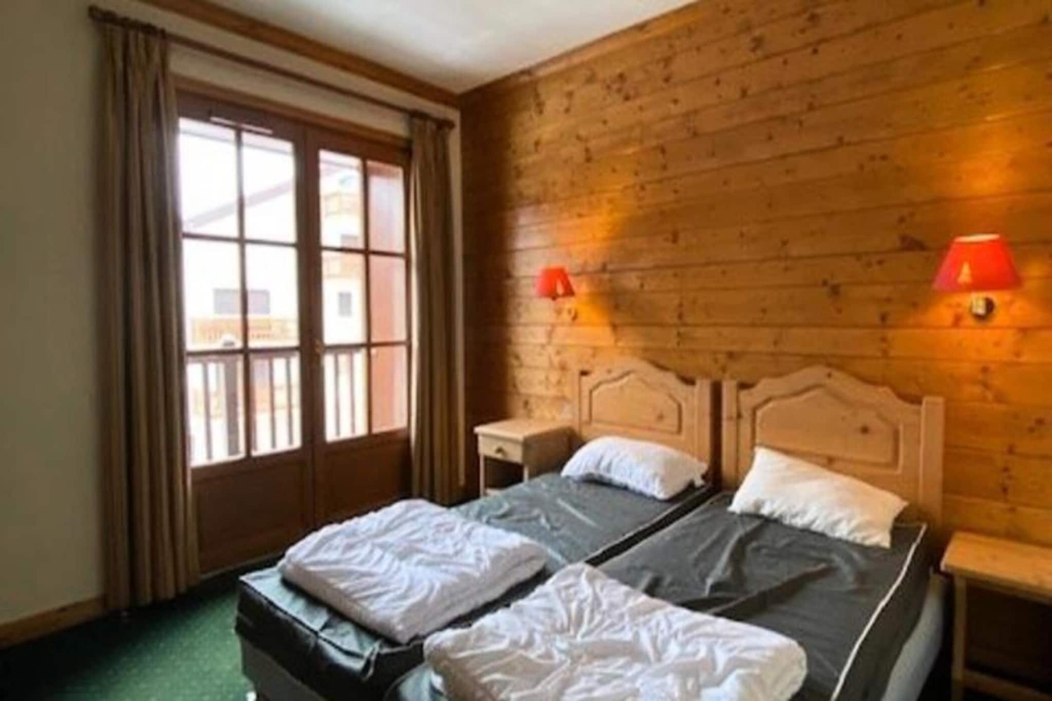 Enhance your mountain getaway with this spacious 66 m² apartment, offering a warm and authentic “mountain chalet” style. Perfect for up to 6 guests, the apartment features two large balconies with stunning views of the mountains, resort, and slopes. Inside, you'll find a cozy living room with a sofa, armchair, TV with cable channels, and a DVD player, as well as a dining area for shared meals. The apartment includes a mountain corner with a 90 cm bunk bed and two comfortable bedrooms, one with a 160 cm bed and the other with two 90 cm beds. A private ski locker and parking space add convenience, and pets are not allowed.
Located in the heart of the resort, this apartment offers direct access to the slopes and the Belle Etoile chairlift, just 200m away. The surrounding area offers everything you need for an enjoyable stay, including the tourist office, bakery, restaurants, shops, and the ESF ski school. With numerous activities available year-round, you'll never run out of things to do, whether you’re skiing in the winter or enjoying the outdoors in the summer.
The apartment is equipped with two bathrooms, one with a bathtub and the other with a shower, as well as towel dryers and hairdryers for added comfort. A fully equipped kitchen, including a dishwasher, coffee maker, microwave, oven, stove, toaster, and kettle, makes meal preparation easy. The apartment also features a second separate toilet for added convenience. End-of-stay cleaning is included, and additional services like bed linen and towels are available by reservation.