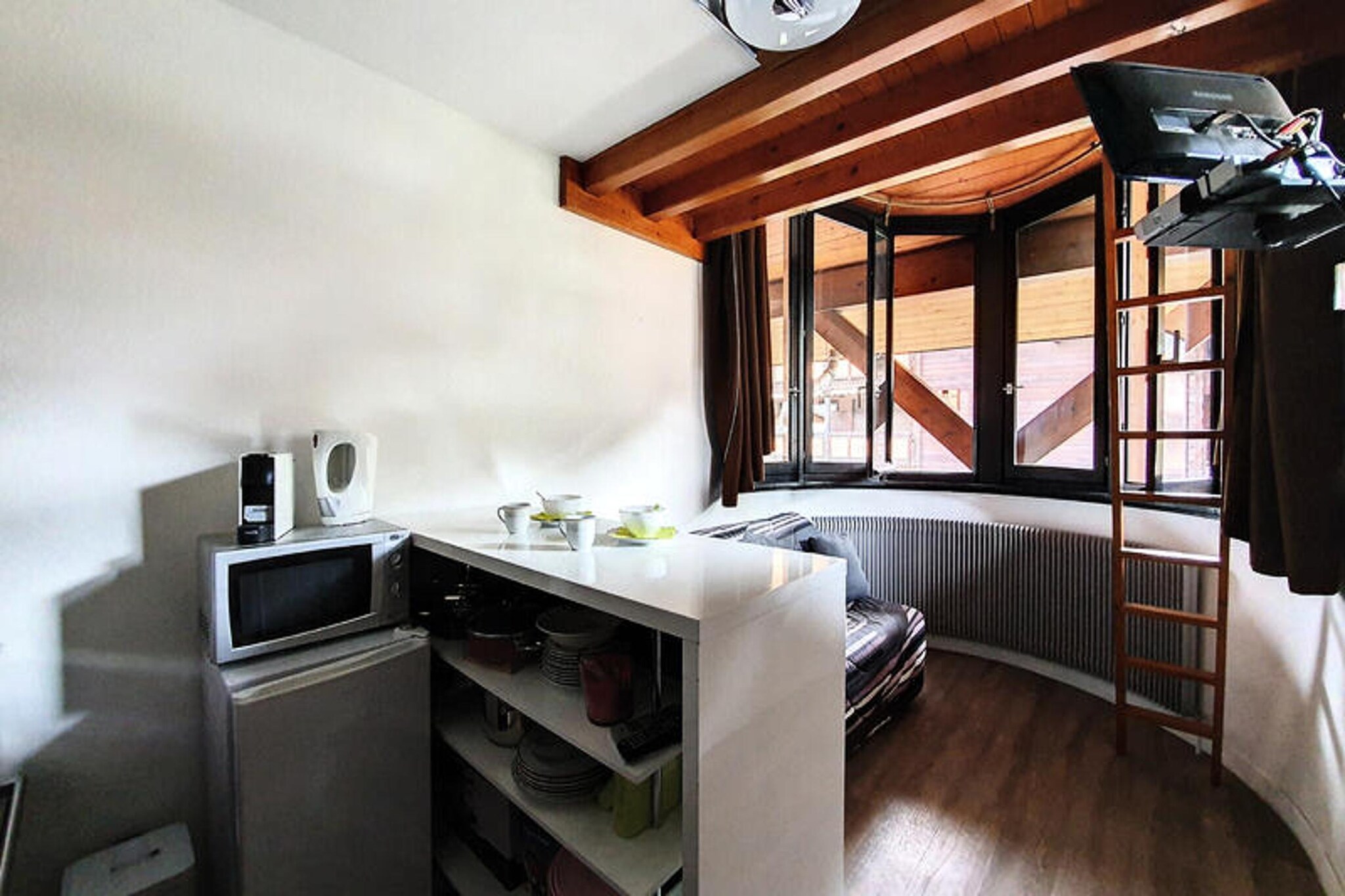 
This cozy studio apartment accommodates up to 3 guests, featuring a foldaway double bed and a convertible sofa bed. It is not pet-friendly and does not provide Wi-Fi. Duvets and pillows are available for all beds, but guests must bring their own bed linens and towels. The apartment offers private parking at the residence, with no designated parking spaces, as well as a bicycle room for summer storage and a ski room for winter use.

Located in the heart of Morzine, the apartment provides easy access to local amenities, including cafes, shops, and restaurants. The center of the city is just steps away, offering a vibrant atmosphere year-round. Ski slopes and outdoor activities are easily accessible, making this apartment the ideal base for exploring the region's natural beauty.

The apartment includes a fully equipped kitchen with an induction hob, refrigerator, freezer, oven, microwave, and a coffee machine. A raclette and fondue machine are also available for guests. The bathroom features a spa shower, towel dryer, sink, and toilet. The bright living room is furnished with a TV and a dining table with 4 stools.