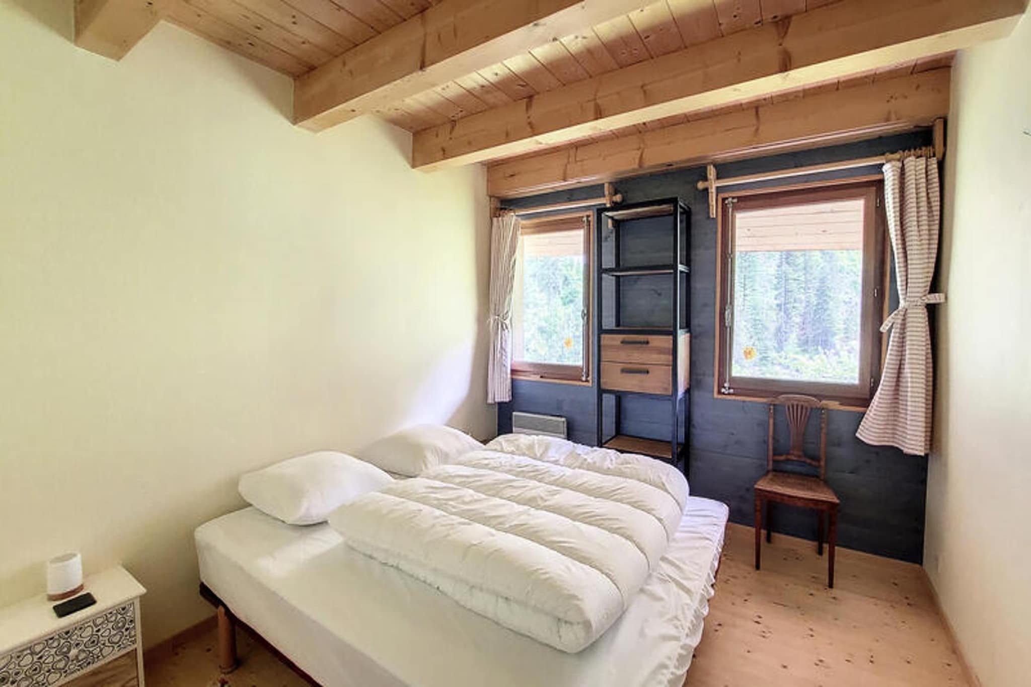 This spacious semi-detached chalet in Seytroux offers a serene retreat for up to six guests, boasting stunning valley views. The chalet features two double bedrooms (140x190 cm) and one twin room with two single beds (90x190 cm). It provides a cozy living room with a fireplace and wood stove, creating a warm ambiance. A smaller reading room with a sofa and television adds to its charm. The property includes a bathroom with a shower, sink, and WC, alongside a practical laundry area. Electric heating ensures comfort year-round, and the chalet is pet-free, ideal for allergy-sensitive guests.

Nestled in the picturesque village of Seytroux, the chalet is an excellent base for exploring the region. Nearby attractions include scenic hiking trails, local markets, and traditional Alpine cafes. In winter, the location is perfect for accessing ski slopes, while summer invites mountain biking and tranquil picnics in the lush surroundings. Seytroux’s authentic charm and vibrant community offer a memorable vacation experience.

The chalet is well-equipped for your convenience, with a kitchen featuring a ceramic hob, oven, dishwasher, fridge, freezer, and microwave. Outdoor amenities include a garden with a dining table, chairs, and a barbecue for summer evenings. Additional conveniences include WiFi, a fondue machine, a travel cot, and ample storage for skis or bikes. Bed linen and towels are not provided, but duvets and pillows are available for all beds.