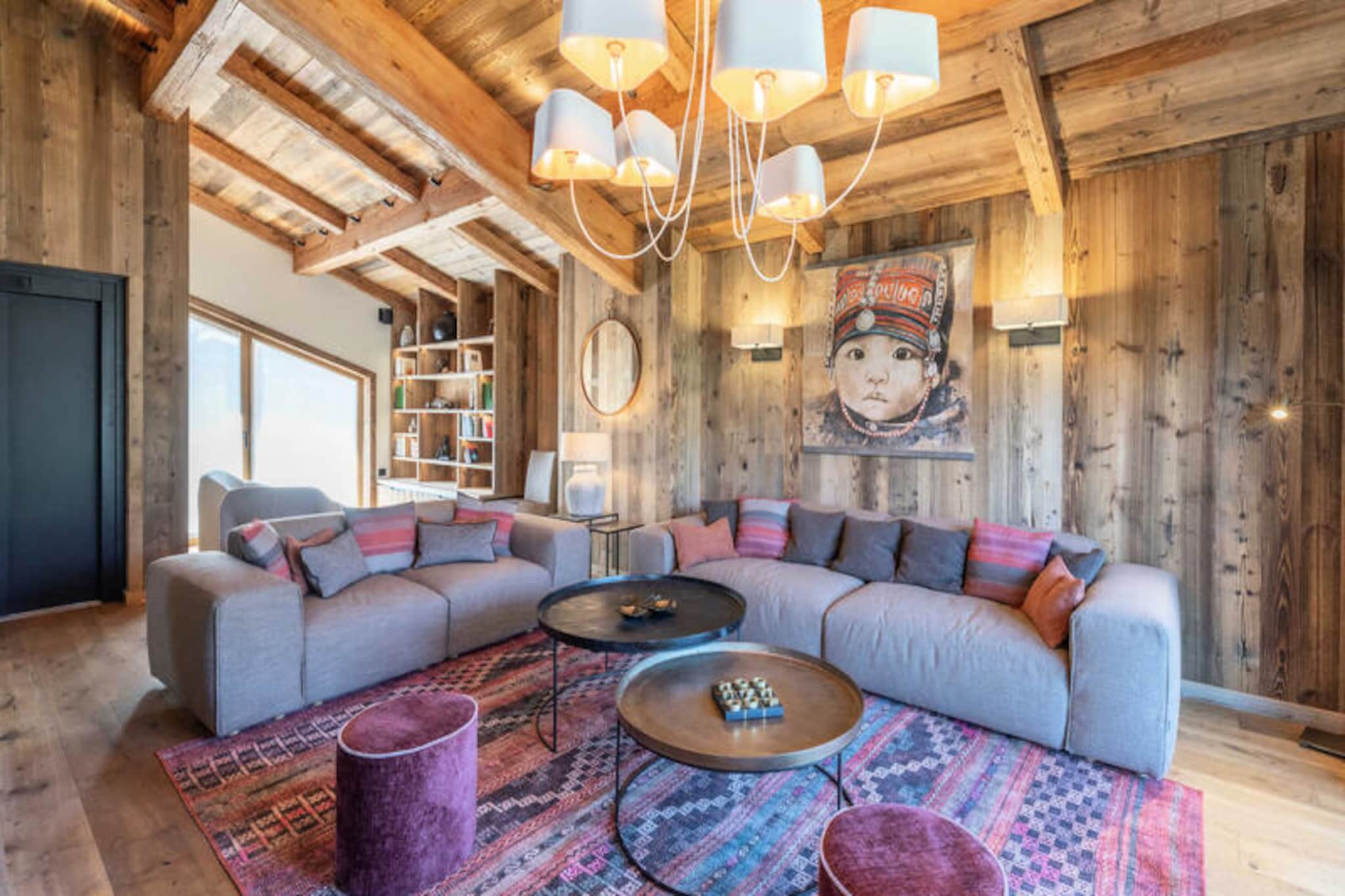 This stunning 4-level chalet offers 270m² of luxurious living space, accommodating up to 10 guests. It features 5 spacious en-suite bedrooms, including a family suite with a parental bedroom and a children's room with bunk beds. The master bedroom includes a balcony and a luxurious bathroom with both a bathtub and shower. The property also includes a ski room with a boot dryer, a safe, and is pet-friendly (for a fee).

Located in the quiet hamlet of Bois du Praz, the chalet is just 400 meters from the village center, where you can explore charming cafes, shops, and restaurants. The nearby ski lifts, only 200 meters away, provide easy access to Courchevel 1850's world-class slopes. Whether you're looking to enjoy the local atmosphere or hit the slopes, this chalet is ideally located for both.

The chalet features a spacious living room with a fireplace, a fully equipped kitchen with a bar, and a cozy reading room. The lower level boasts a relaxation area with a swimming spa, sauna, and herbal tea room, ensuring ultimate comfort after a day of skiing. Additionally, there is a balcony and terrace to enjoy the panoramic views of the surrounding area.