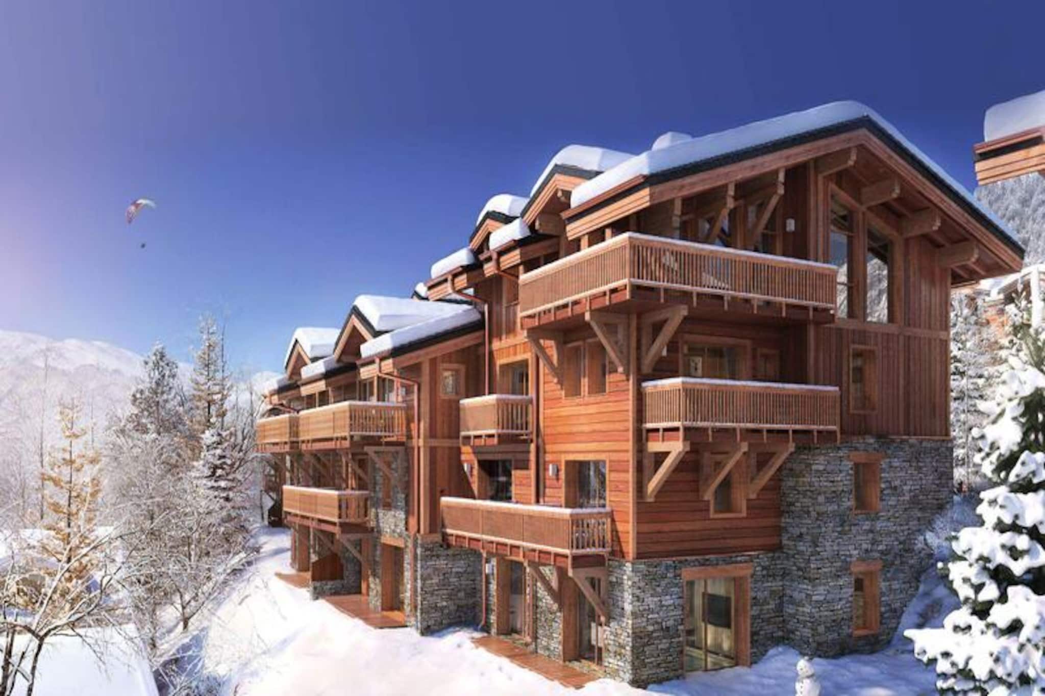 This luxurious 100m² apartment, located in a two-unit chalet, comfortably accommodates up to 7 people across 3 bedrooms. Two of the bedrooms are en-suite, including one with a double bed (180x200) and another with a set of bunk beds and a pull-out bed. The apartment is non-smoking and does not allow pets. Additional features include a TV lounge with a gas fireplace and a sauna for four people, perfect for unwinding after a day on the slopes.

Located just 400 meters from the Ariondaz gondola, this apartment offers direct access to the 3 Valleys ski area, renowned for its extensive and varied slopes. Courchevel Moriond’s shops, restaurants, and the French Ski School are also within easy reach, ensuring that all your needs are met while enjoying the serene surroundings of the Glaciers area.

The apartment features an open, fully equipped kitchen with two refrigerators, an oven, a dishwasher, and a microwave. The dining area can seat up to 10 guests, and the property includes a ski locker with a boot dryer for 10 pairs of boots. For added convenience, the apartment includes a washing machine and dryer, and a cellar for additional storage.