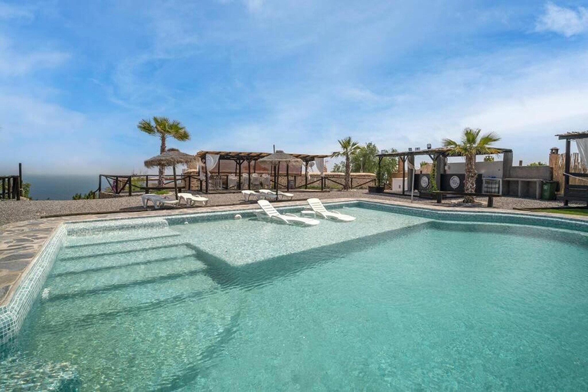 This charming country house, restored in 2022 using local stone, offers breathtaking views of the sea and mountains. Located in a serene and picturesque setting, it’s perfect for outdoor enthusiasts and just 10 minutes from the area's best beaches. The property consists of three houses, each with a private entrance, ensuring privacy and comfort. The house features three cozy double bedrooms and a sofa bed, ideal for a child’s comfort.
Guests can start their day on the spacious 60 m² terrace or outdoor porch, enjoying the magnificent sea and mountain views. Nature lovers will appreciate the nearby Natural Park of Punta Entinas-Sabinar, while foodies can explore the culinary delights of the Adra region. For relaxation, the complex offers a shared swimming pool with a shallow area for children, a solarium, Balinese beds, and a barbecue area.
The La Suerte complex is a perfect retreat for those seeking peace and comfort, complete with an outdoor relaxation area, fruit trees, a bar for cocktails, and ample parking for multiple cars. Whether you’re unwinding by the pool or exploring the stunning surroundings, this country house is a true haven.