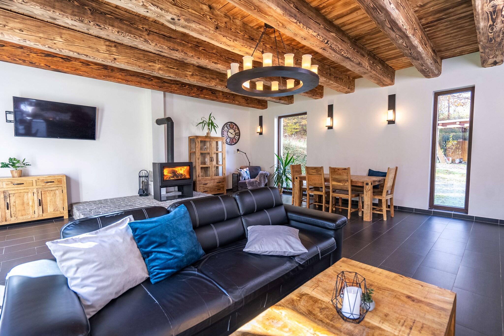 This modern villa in Lešany offers a cozy retreat with four bedrooms, accommodating up to 15 guests. Spanning 290 m², it boasts beautiful views of the garden and is situated in a child-friendly neighborhood surrounded by serene countryside. The property features essential amenities, including a garden and garden furniture, a spacious 70 m² terrace, and a barbecue area for outdoor gatherings.
Guests can indulge in various on-site amenities, including a sauna and a jacuzzi for relaxation. The villa also provides free Wi-Fi, a TV with satellite/cable access, and central heating for comfort year-round. For convenience, the property includes open-air parking for up to five vehicles.
The well-equipped open-plan kitchen features modern appliances such as a refrigerator, microwave, oven, and dishwasher, along with essential dishes and kitchen utensils. A coffee machine and kettle are also available, ensuring guests can enjoy warm beverages during their stay. This villa combines comfort and functionality, making it an ideal choice for family vacations or group getaways.