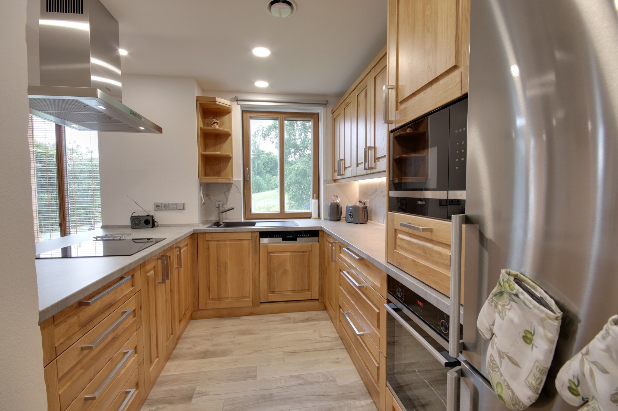 This spacious villa, located in Korenov, offers an ideal retreat for up to 12 guests. Perfect for families or groups, it features two luxuriously equipped apartments, allowing for privacy if needed. The property is pet-friendly, ensuring everyone in your group, including pets, is comfortable. With 5 bedrooms and 3 modern bathrooms, there's plenty of space for all guests. The bathrooms are sleek, with high-quality finishes and powerful showers, while the well-equipped kitchen has everything needed for preparing delicious meals, from a fridge and microwave to an oven and dishwasher.

The villa is situated just 2 km from the popular U Capa ski resort, making it a prime spot for winter sports enthusiasts. During the summer, the area offers a variety of outdoor activities, including hiking in the Jezerske Hory nature reserve, or cycling along local bike trails. The nearby Tanvaldsky Spicak ski area is just a short drive away, and the town also offers cultural experiences and charming markets. A swimming pool in Tanvald, only 5 km from the villa, provides a perfect place to relax after an active day.

The villa is equipped with all the amenities needed for a comfortable stay. It features a fully equipped kitchen for preparing meals, a cozy living room for entertainment, and a spacious garden with playground equipment for kids. Parents can relax on the terrace or light the barbecue in the evening to enjoy a lovely meal outdoors. The villa also offers a laundry area with a washing machine and dryer for your convenience.