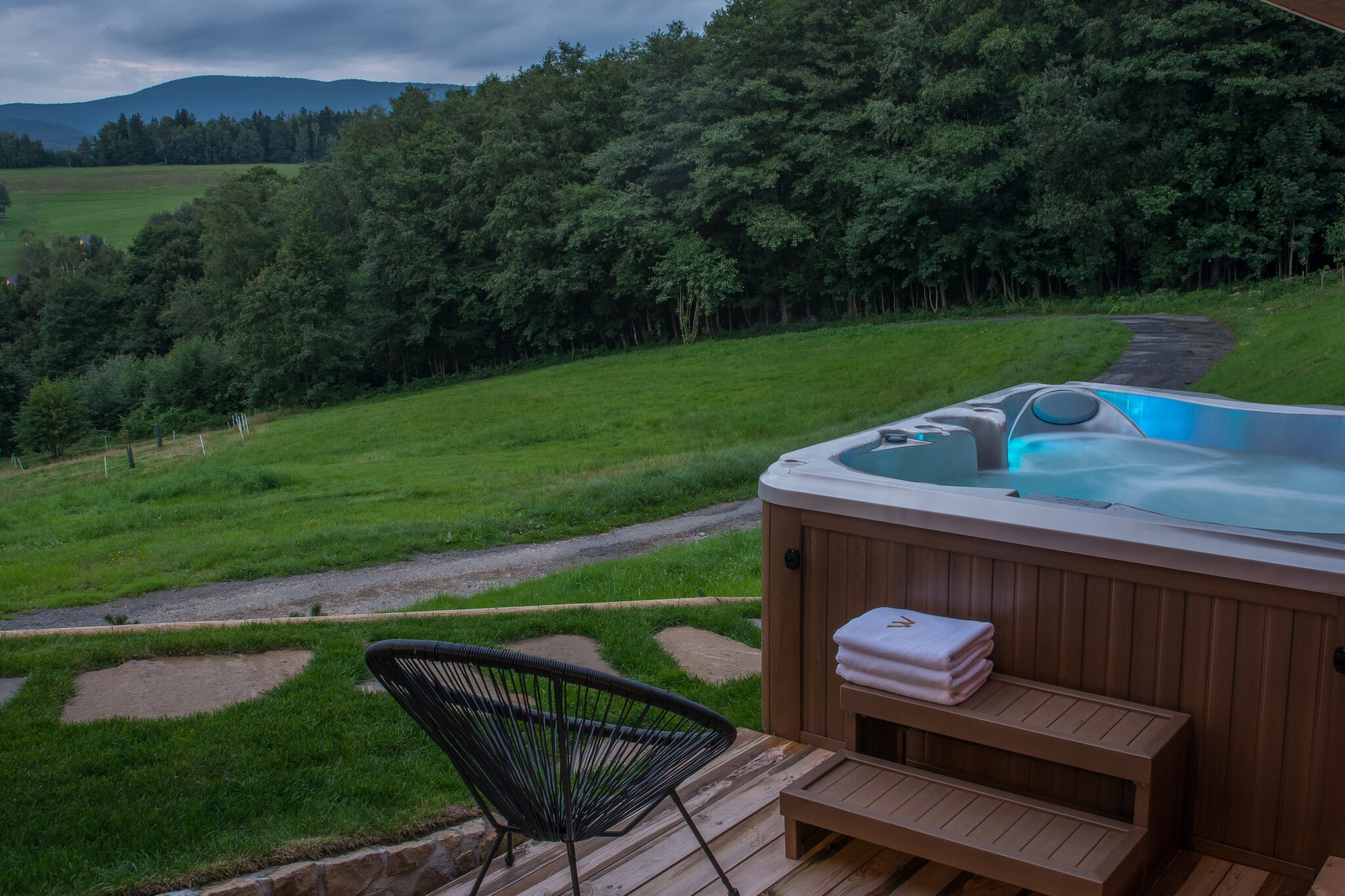 Ground floor: (open kitchen(hob(ceramic), electric kettle, hood, coffee machine, oven, microwave, dishwasher, fridge, freezer, high chair, Food processor), Living/diningroom(TV, dining table, fireplace, seating area), bedroom(single bed, double bed), bedroom(single bed, double bed), bedroom(single bed, double bed), bedroom(double bed), bathroom(bath tub, washbasin, toilet), bathroom(shower, washbasin, toilet), bathroom(shower, washbasin, toilet), toilet(toilet), Internet access)\n\nrelaxation area(sauna, Bubble bath), tumble dryer, washing machine, heating(central), terrace(30 m2), garden, garden furniture, BBQ, parking