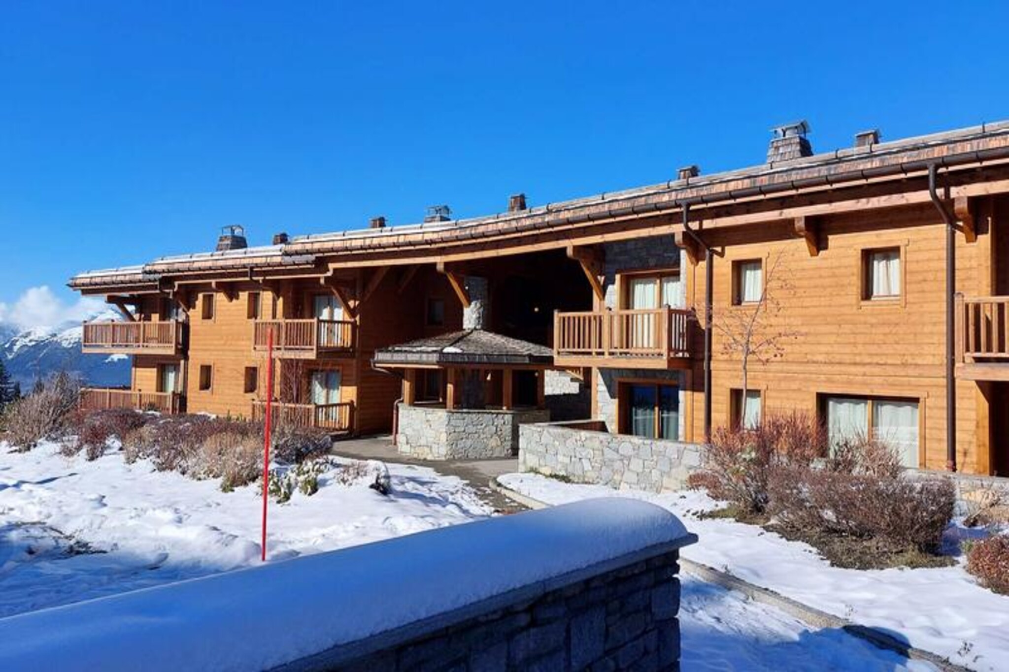 This charming three-room ground-floor apartment in the quiet Chantel village accommodates up to six guests. It features a living room with a double sofa bed, a bedroom with a double bed, and a second bedroom with two single beds. Pets are not allowed, and the apartment is non-smoking. The apartment has an east-facing balcony. A ski locker and a parking space are provided. Guests have free access to the building's swimming pool. Bed and bathroom linen are included.
Located in a quieter area of Arc 1800, this apartment offers easy access to the slopes. Guests can ski directly from the residence to the "Vagère" or "Carreley" chairlifts and the "Villards" gondola. The free "Dahu" cable car is 100 meters away, and a free shuttle bus stop is just 50 meters away, running every half hour in winter and hourly in summer. A mini-market is 100 meters away in the village. The Tourist Office and medical office are located below in the Charvet village, and the ESF ski school is on the resort's snow front.
The apartment includes a shower and a separate toilet. The open-plan kitchen is fully equipped with ceramic hobs, an oven, a dishwasher, a refrigerator, a coffee maker, a kettle, and a toaster. A television and free Wi-Fi are provided. Bathrobes are not included.