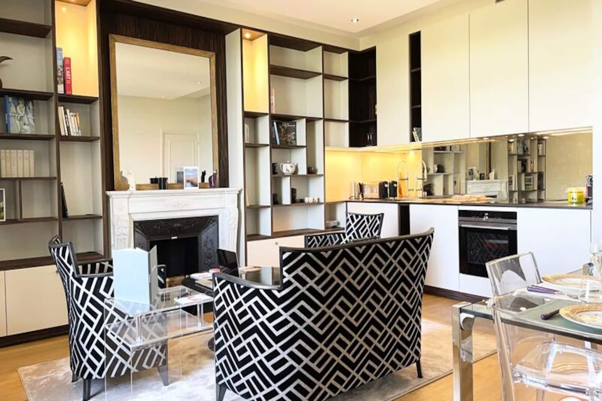This elegant luxury apartment is located in a prestigious building, offering a chic and stylish stay for up to 3 guests. The apartment features a spacious living room with an open kitchen and dining area, providing a view of the castle park. The master suite is equipped with a quality double bed, while the second bedroom/office includes a pull-out bed and a cozy reading corner. The apartment also offers a bathroom with an Italian-style shower. It’s located on the second floor with elevator access, ensuring easy mobility.

The property is ideally situated near several attractions. Guests can enjoy the stunning view of the Deauville-la Touques racecourse and Trouville-sur-Mer, with a glimpse of the sea. Golf enthusiasts will appreciate the proximity to the Golf Barrière, just 300 meters away. The city center, Place Morny, the casino, and the beach are all within a 15-minute walk or a 5-minute bike ride, providing access to a range of cafes, shops, and entertainment.

The apartment is equipped with modern amenities for a comfortable stay, including Wi-Fi, a washing machine, dishwasher, and a safe. Guests can relax in the park with two deckchairs provided. The kitchen area is fully equipped, making it easy to prepare meals, while the bathroom is equipped with high-quality fixtures. Bed and bath linens are provided, ensuring a pleasant and hassle-free stay.