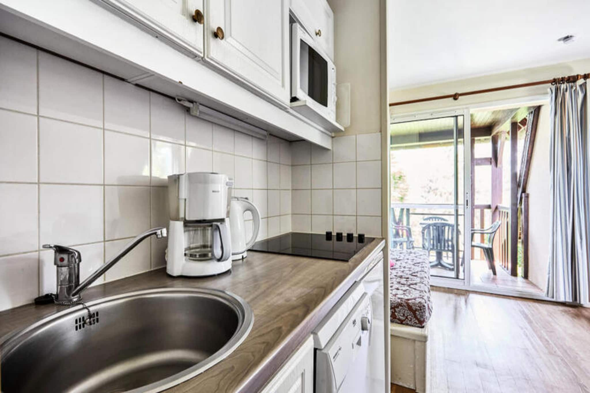 This 2-room apartment in Deauville offers a comfortable and convenient base for your getaway, ideal for families or groups of up to 4 people. Located in a quiet area on the outskirts of town, the apartment complex boasts a heated outdoor swimming pool (open seasonally) and a paddling pool for children. While the beach is 2.5km away, the peaceful setting offers a relaxing escape. 

The apartment itself features a living room, a well-equipped kitchen, a bedroom, a bathroom, and a separate toilet. The apartment also includes free covered parking for added convenience.  While some amenities like Wi-Fi, pet access, and linens require extra fees, the apartment provides everything you need for a comfortable stay, including essential appliances.

**Please Note:**

* The specific apartment you will be staying in may vary.
* Pets are allowed for an additional fee.
* Housekeeping is not included but can be arranged for an extra charge.
* Optional services like Wi-Fi, linens, and baby kit are available for an additional cost.

This apartment is a great choice for those seeking a comfortable and affordable stay in Deauville, with the convenience of a pool and a quiet location.