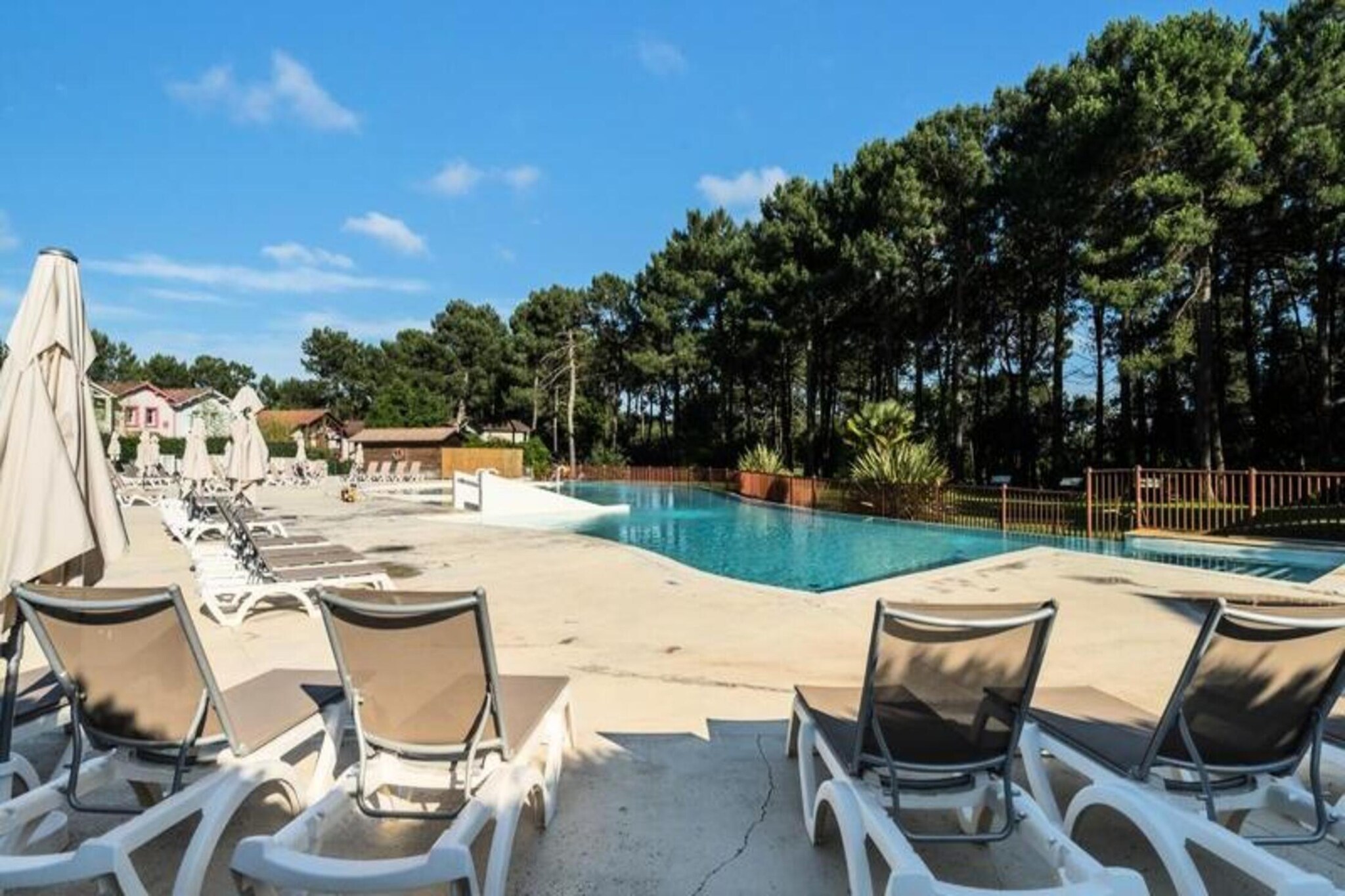 Nestled within a magnificent 5-hectare pine forest, this spacious apartment is ideal for a peaceful family or group getaway. The property can accommodate up to four guests, with a bedroom offering a comfortable double bed and a living room with a sofa bed. The residence is pet-friendly, allowing you to bring your furry companions along (subject to additional charges). While bed linen and towels are available for an additional fee, a cleaning kit is provided for convenience.
The location offers easy access to a variety of nearby attractions, including Lacanau's beaches, which are just 2-3 km away. The area is a haven for outdoor activities, from cycling along scenic paths to enjoying surfing on the Atlantic coast. Guests can also take advantage of the residence's leisure facilities, including a swimming pool, paddling pool, and courts for beach volleyball and pיtanque. The nearby town offers shops, cafes, and restaurants, ensuring that all your needs are met within a short distance.
The apartment features a fully equipped kitchen with essential appliances, including a microwave, oven, and dishwasher. The bathroom includes a shower, and the apartment has a separate toilet. You can enjoy a relaxing time in the private apartment, with access to the residence's free parking and a swimming pool open from June to September. For additional services, such as baby kits or extra cleaning, please inquire with the reception.