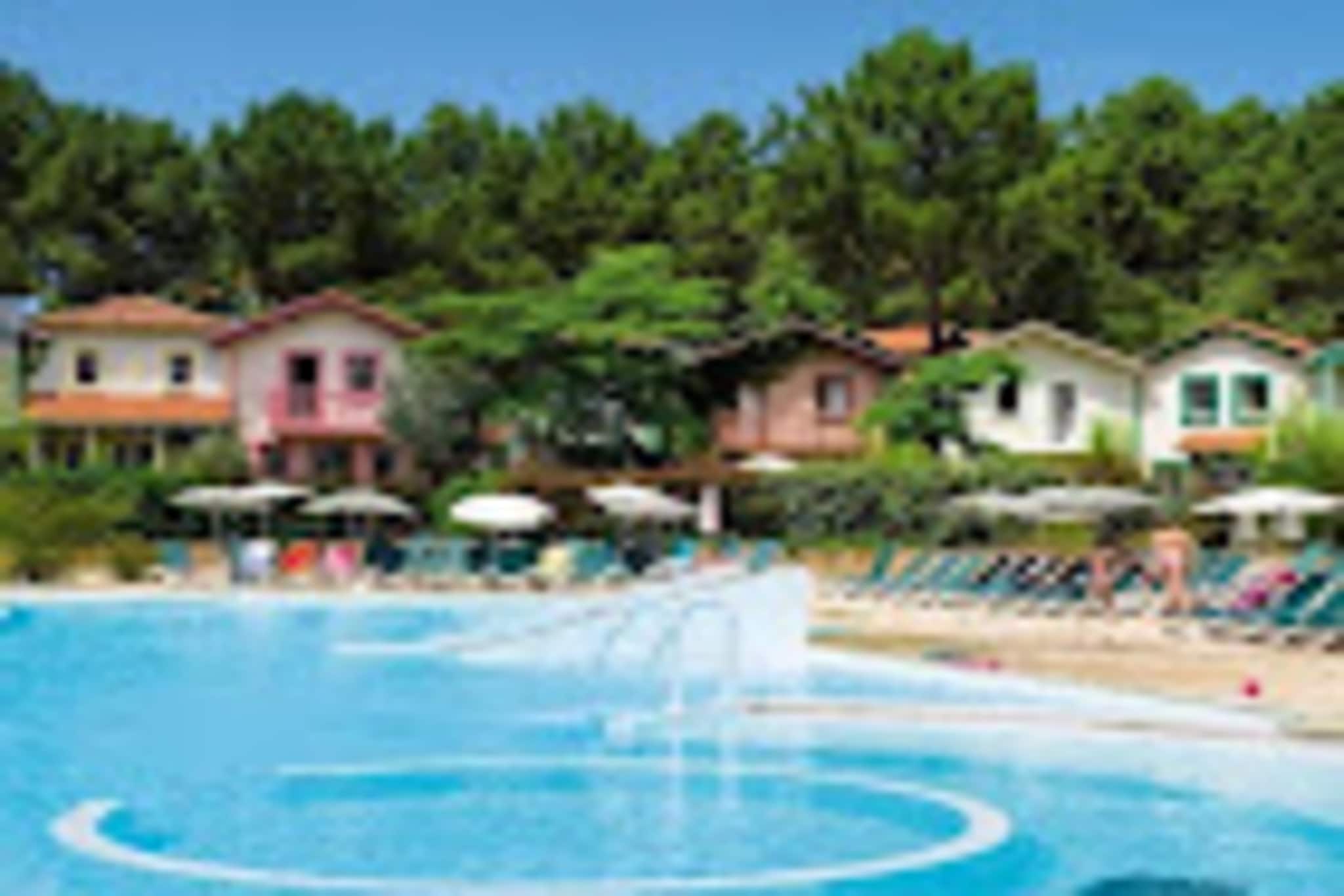 This residence, nestled in a 5-hectare pine forest less than 3km from Lacanau Océan's beaches and center, offers a tranquil setting with a superb aquatic area overlooking a golf course. This particular 32 sq m, two-room apartment accommodates up to five guests. While pet policies aren't explicitly stated, it's best to inquire with the residence directly. Free, unnumbered parking is available on-site.

The location provides easy access to both nature and the amenities of Lacanau. Guests can enjoy the residence's aquatic area (swimming pool and paddling pool), beach volleyball, multi-sport court, children's play area, and pétanque court. Lacanau is also known for its long surfing beaches. Bike rentals are available on-site through Bicy'cool, and Evolution 2 offers activities for ages 6+, including yoga and swimming classes. Lake Lacanau and the ocean beaches are 2km and 3km away, respectively.

This "maeva Home Prestige" labeled apartment provides recently renovated and tastefully decorated accommodations. It comprises a living room, a kitchen area, a bedroom, a bathroom, and a toilet. A maintenance kit is included. Bed linen, towels, and end-of-stay cleaning (except for Prestige, Exclusive, and maeva super Home categories, where it's included except for the kitchen) are available for an additional charge. A baby kit is also available upon request (subject to availability and pricing).