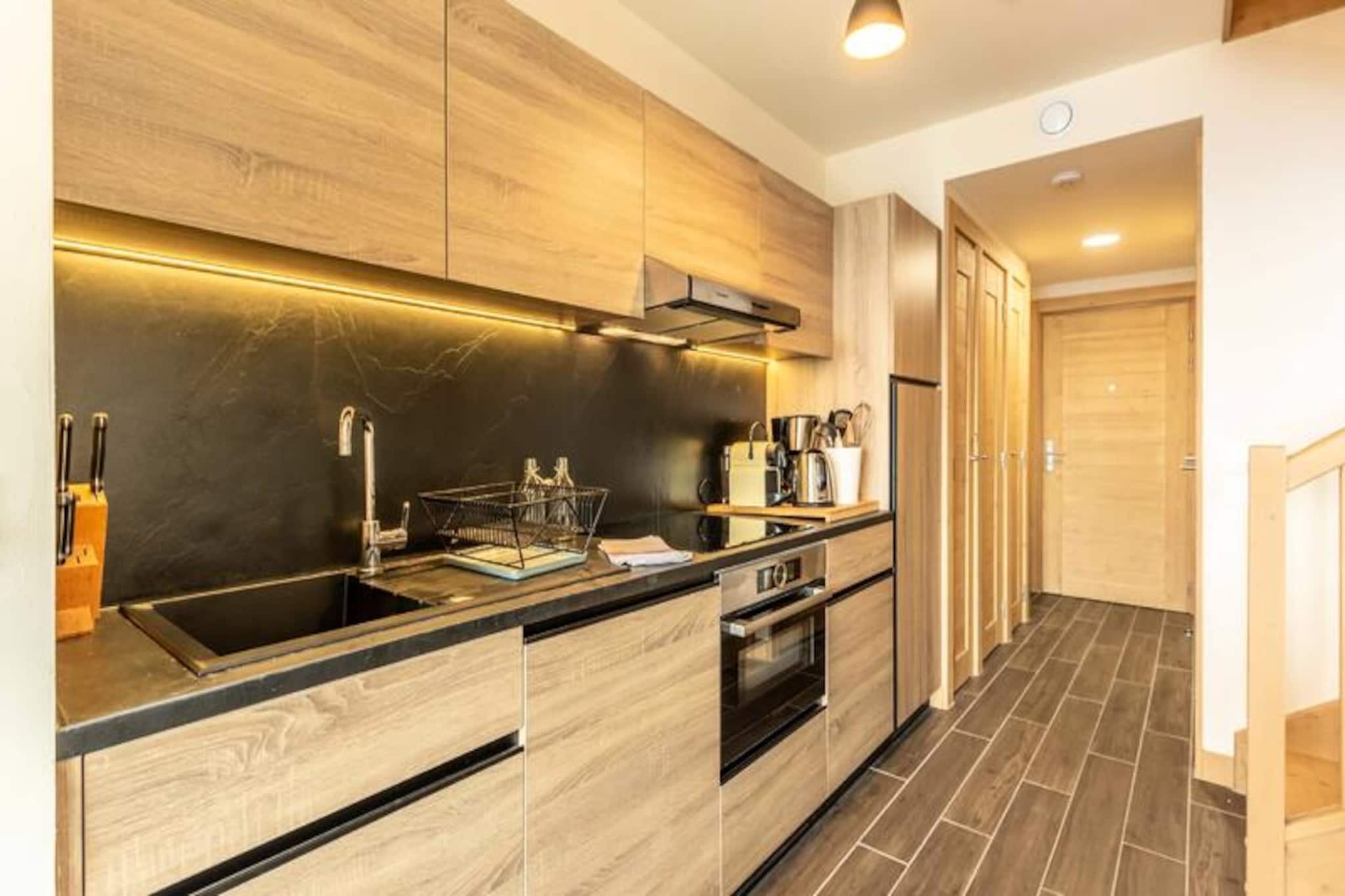 This luxurious duplex apartment is located in a high-end residence, perfect for 4 to 6 guests. It features two bedroom suites with two 80x190 cm beds, each with a shower room and storage. The spacious living room includes a double sofa bed, a large balcony, and a TV. The apartment also has a bathroom with a heated towel rail, a separate toilet, and all essential amenities. Beds are made upon arrival, and bathroom linens are provided. Pets are not allowed, and the apartment is non-smoking.

Set at the foot of the slopes, the residence offers ski-in and ski-out access. The nearby ESF beginner area is ideal for private lessons, making it perfect for families or beginners. The resort is centrally located between Arcs 1950-2000 and Arcs 1800, providing easy access to Paradiski. Guests can also enjoy local cafes, restaurants, and the "French Touch" grocery store, offering takeaway meals and deliveries of bread and pastries.

Guests can unwind with access to the wellness area, including a swimming pool, spa, sauna, hammam, and gym. The apartment includes a fully equipped kitchen with a Nespresso coffee machine, dishwasher, and microwave. Additional amenities include concierge service, ski locker, Wi-Fi, and TV lounge for a relaxing stay.