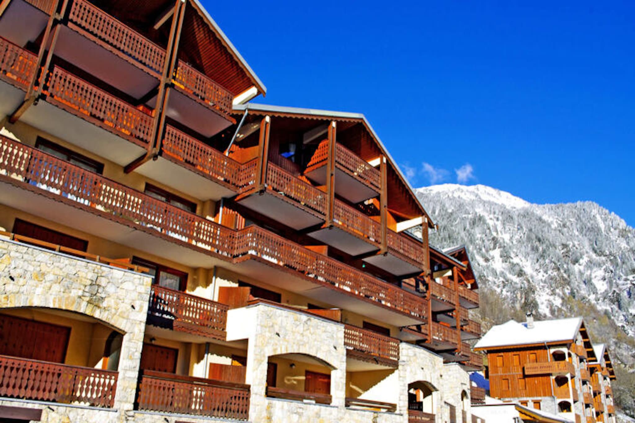 This cozy and well-appointed apartment offers an ideal retreat for up to six guests. It features a comfortable bedroom with a double bed, an entrance area with foldable bunk beds, and a living room with a sofa bed. The apartment also includes a modern shower room, separate toilets, and a sunny south-facing balcony that provides stunning views of the village and surrounding mountains. Please note that pets are not allowed, and the property is non-smoking.

Situated just 200 meters from the village center, the property is perfectly positioned for guests to enjoy nearby shops, restaurants, and the gondola leading to the ski slopes. The area offers access to the ESF ski school, making it a great choice for families or beginners. Guests can also explore local markets and cafes, or simply relax and take in the tranquil alpine surroundings.

The apartment is equipped with all the essentials for a comfortable stay, including a kitchenette with a dishwasher, oven, microwave, and refrigerator. Guests will also find a coffee maker, toaster, kettle, and all necessary crockery for convenient meal preparation. Additional amenities include a ski locker, television, and optional services like WiFi and baby equipment for a small fee. With its sunny balcony and excellent location, this property offers a relaxing mountain getaway.